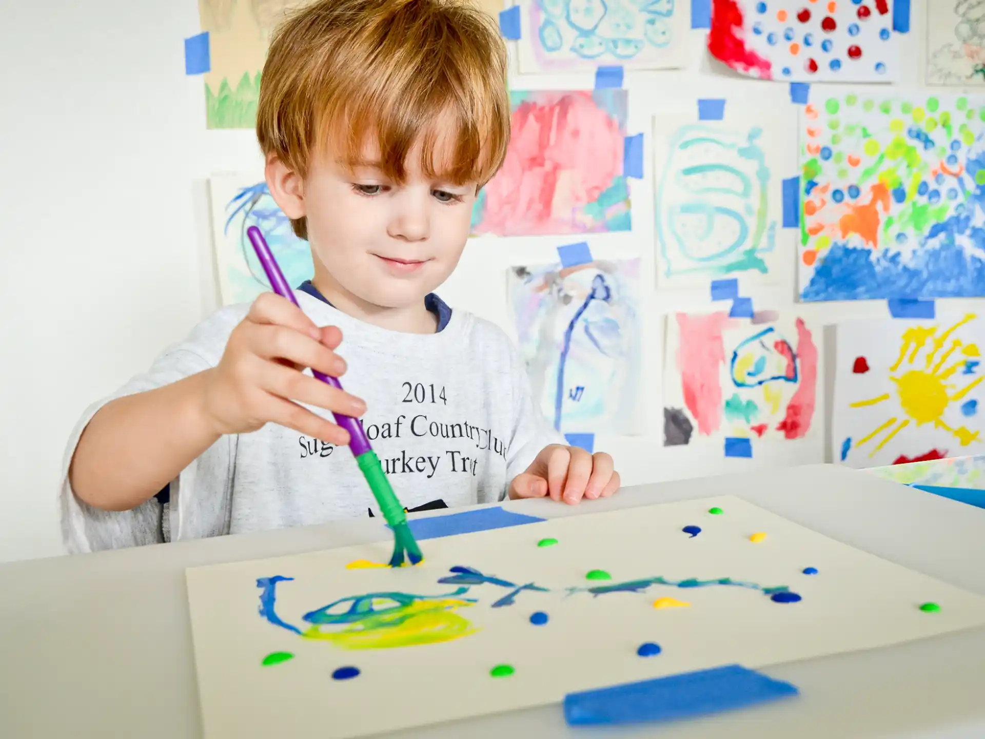 a child painting on a table