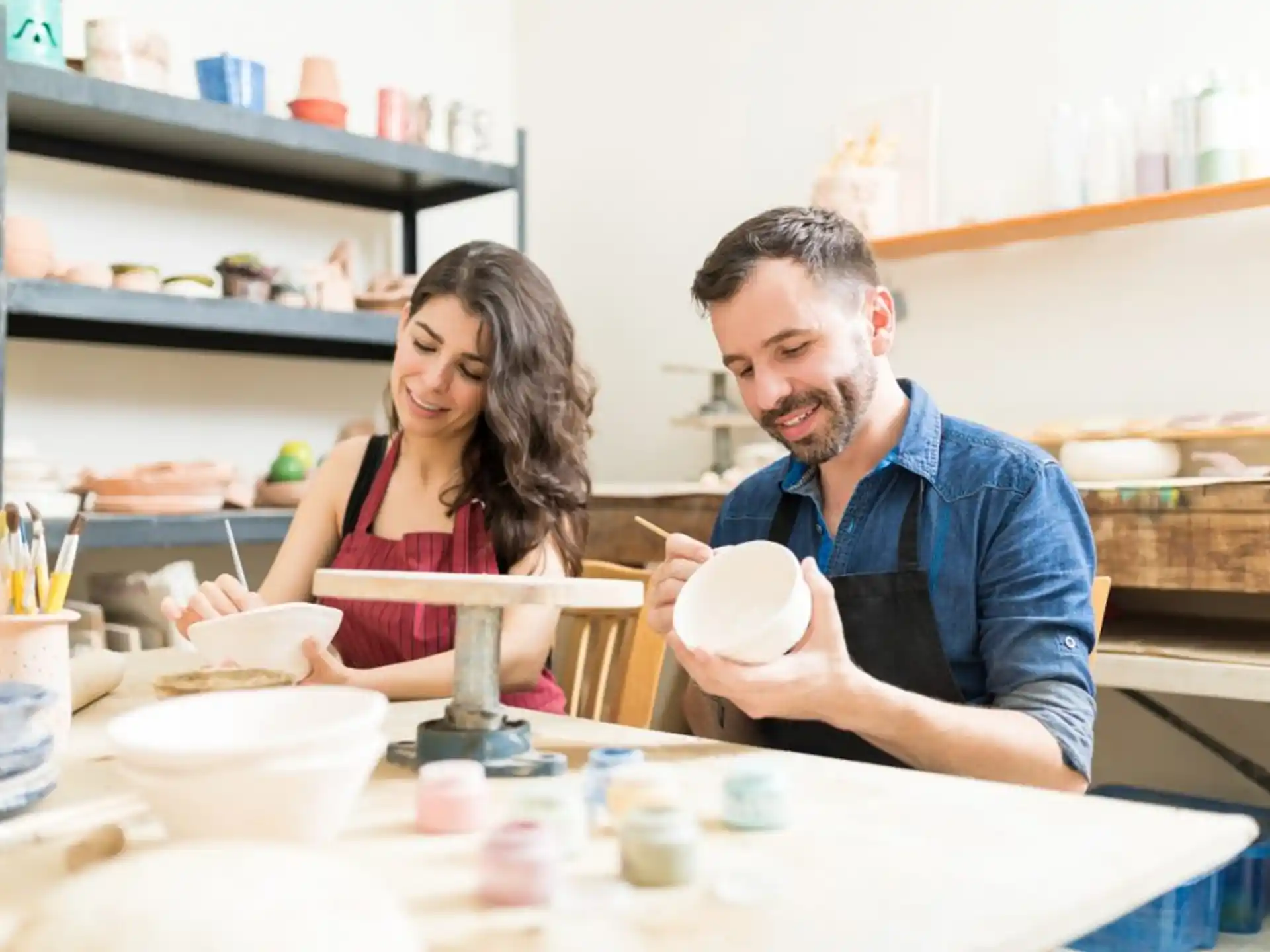 a man and woman sitting at a table with food