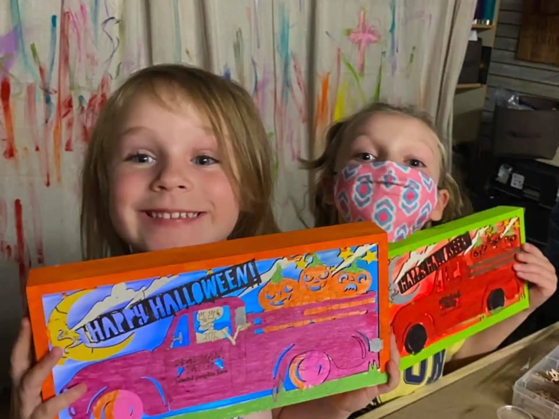 a couple of children holding a toy train