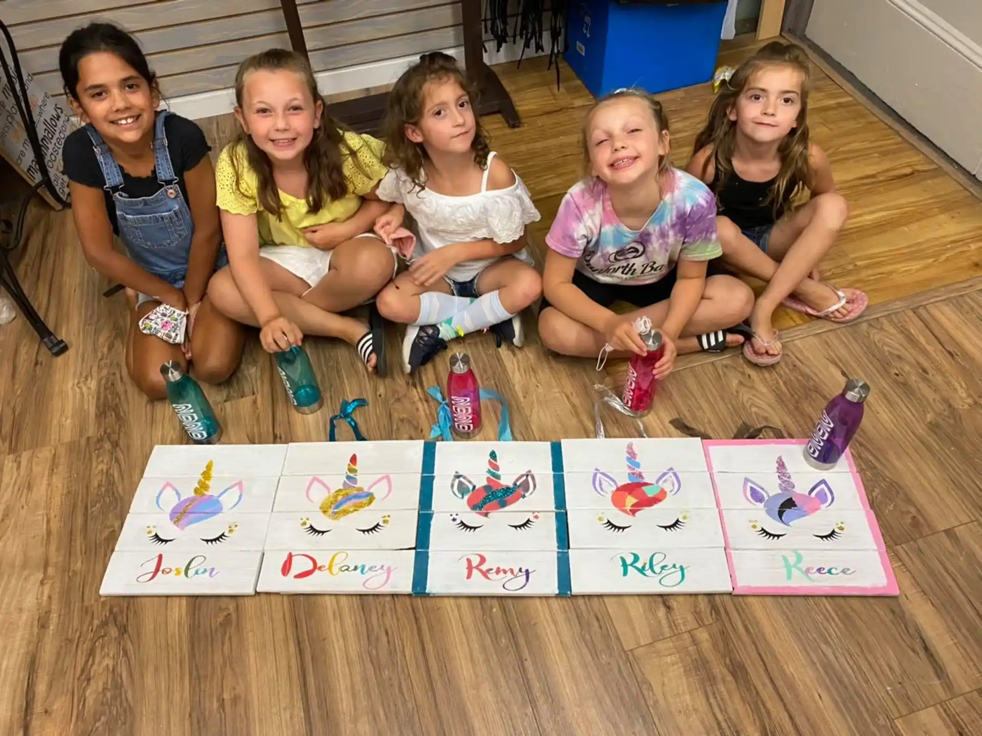 a group of girls sitting on the floor with a board game