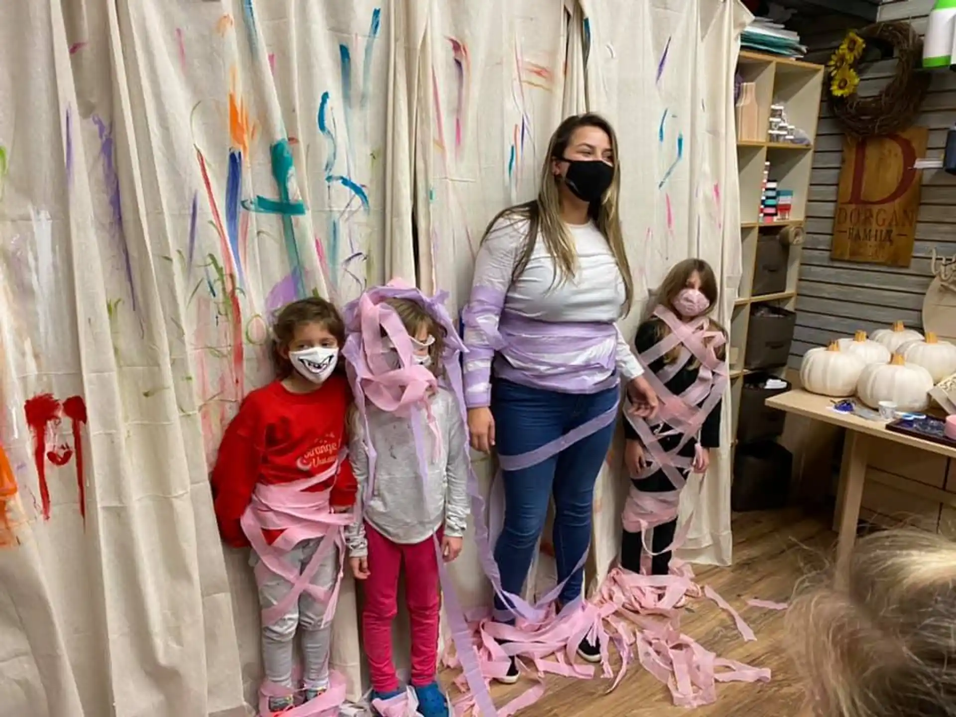 a person and a group of children wearing masks