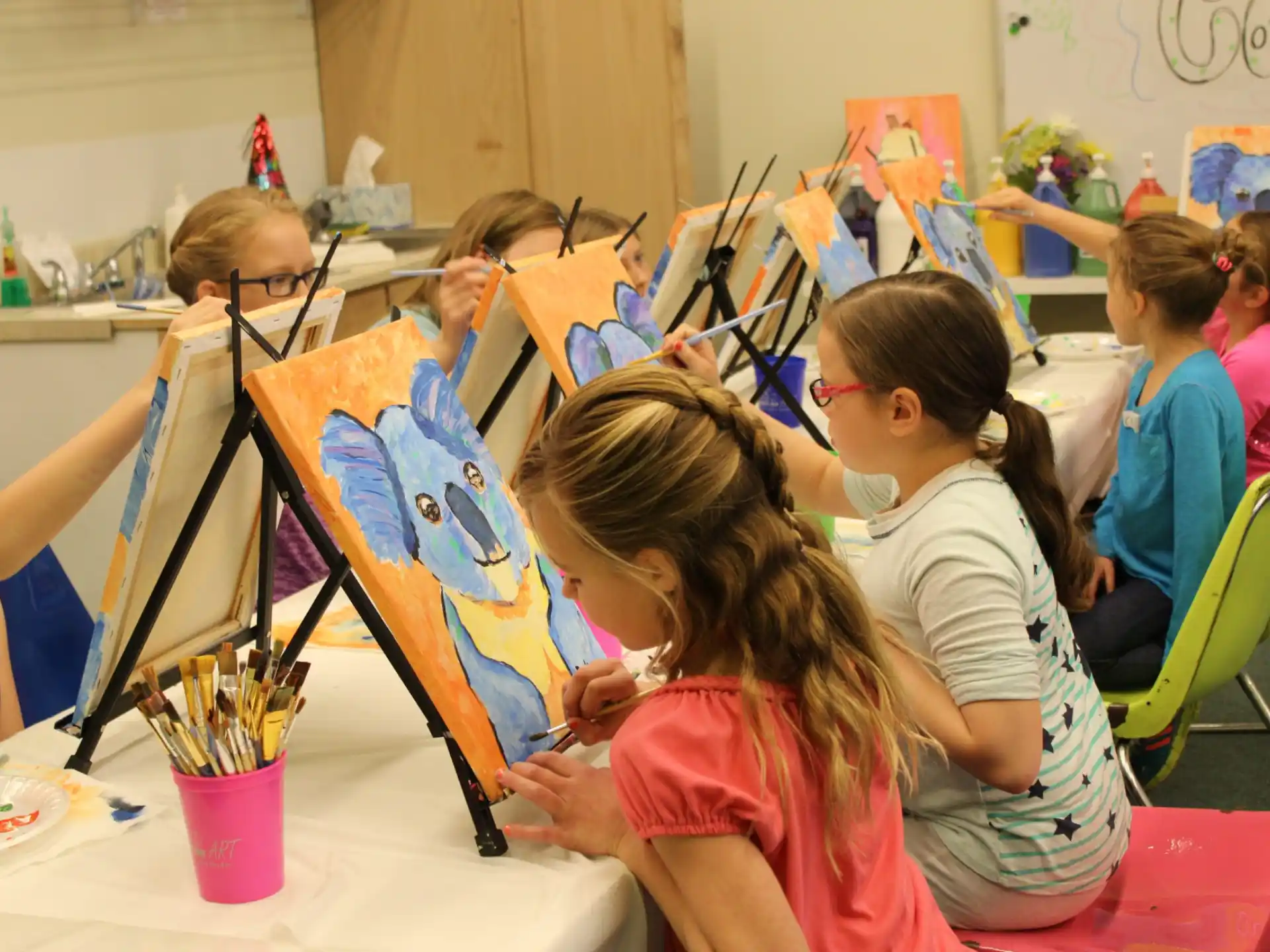a group of children painting