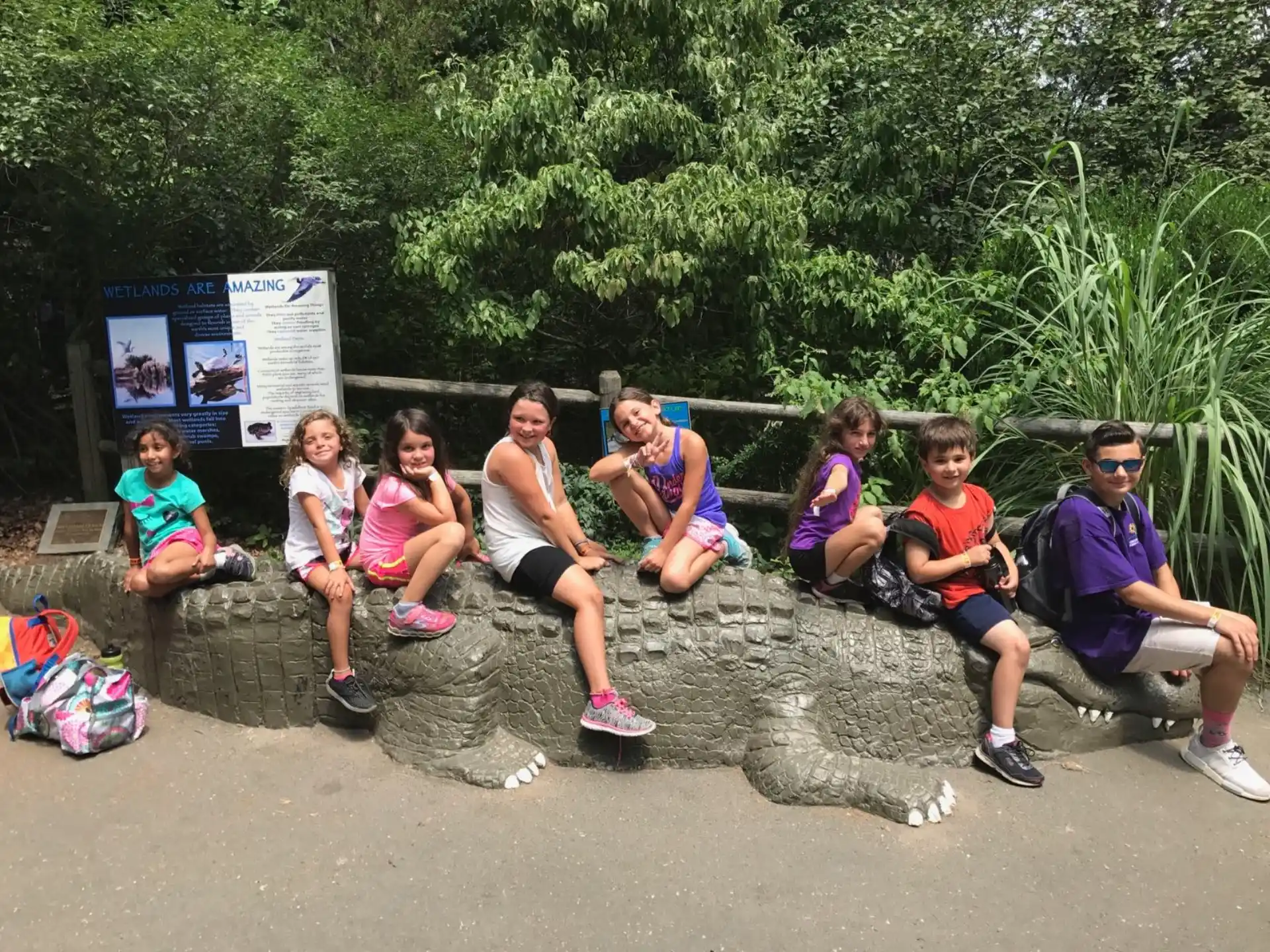a group of people sitting on a rock
