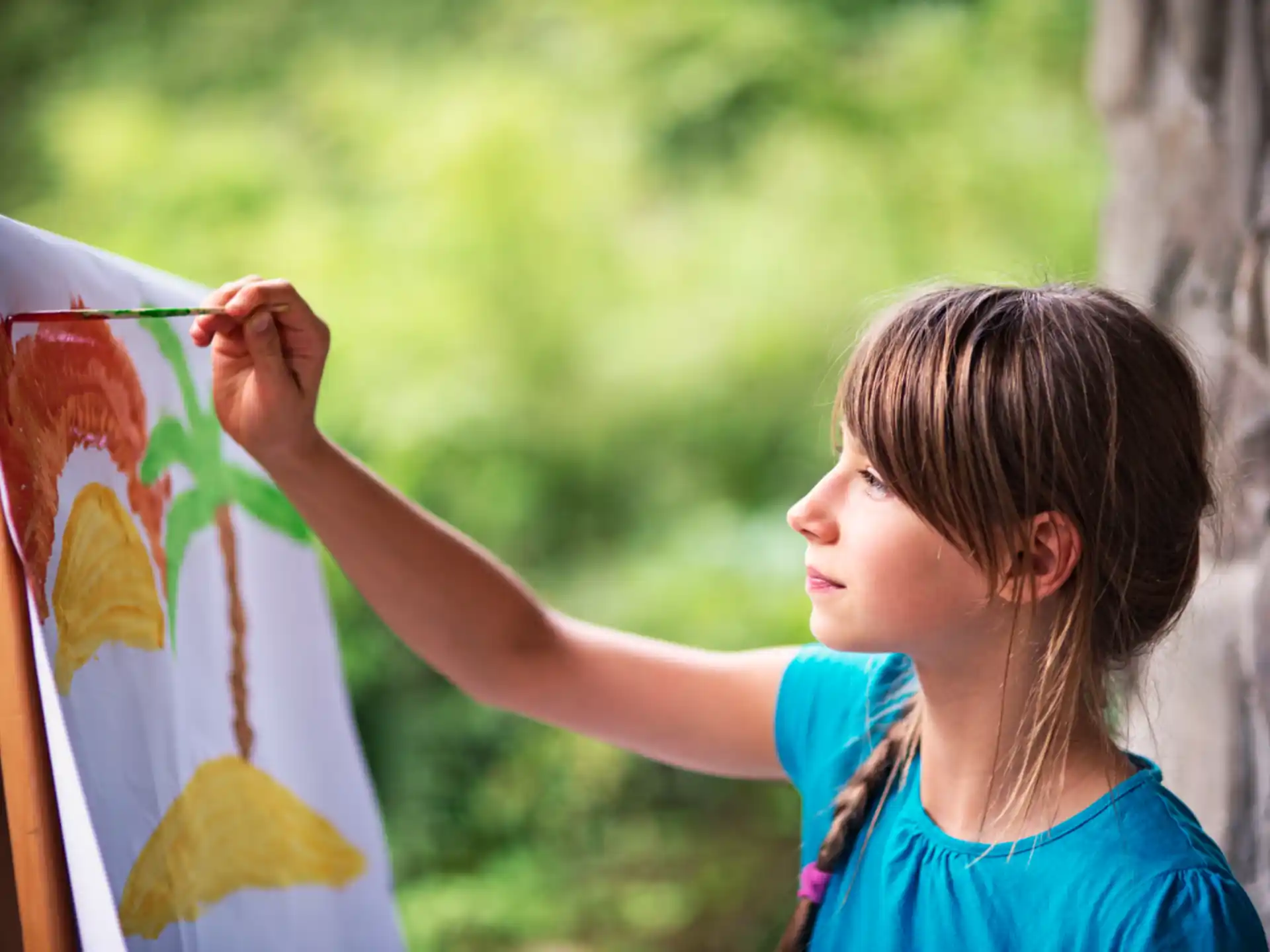 a girl painting a picture