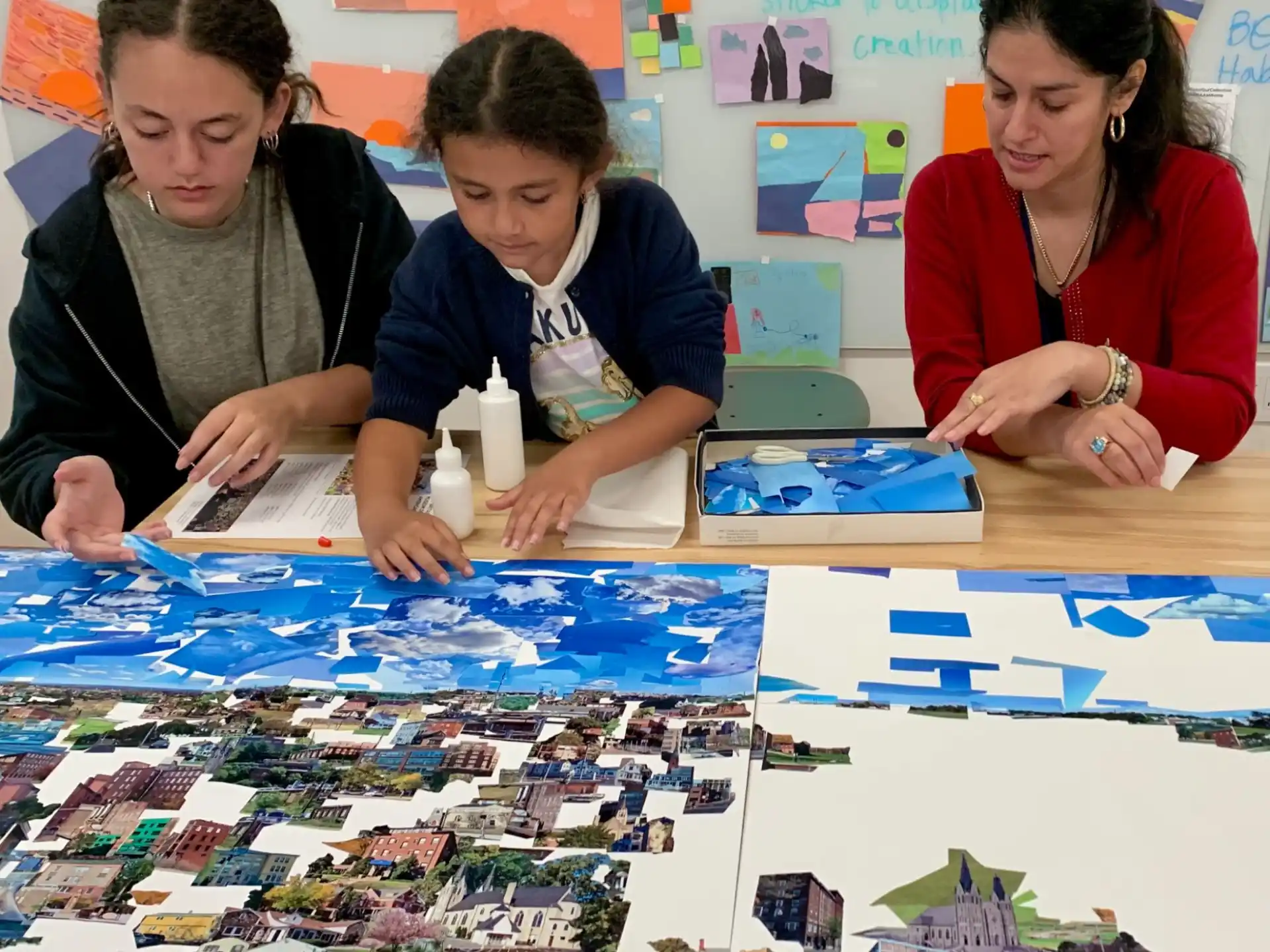 a group of people sitting at a table with a map