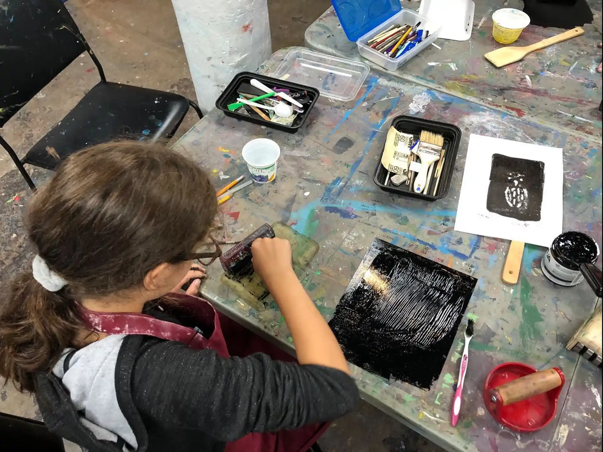 a girl painting on a table