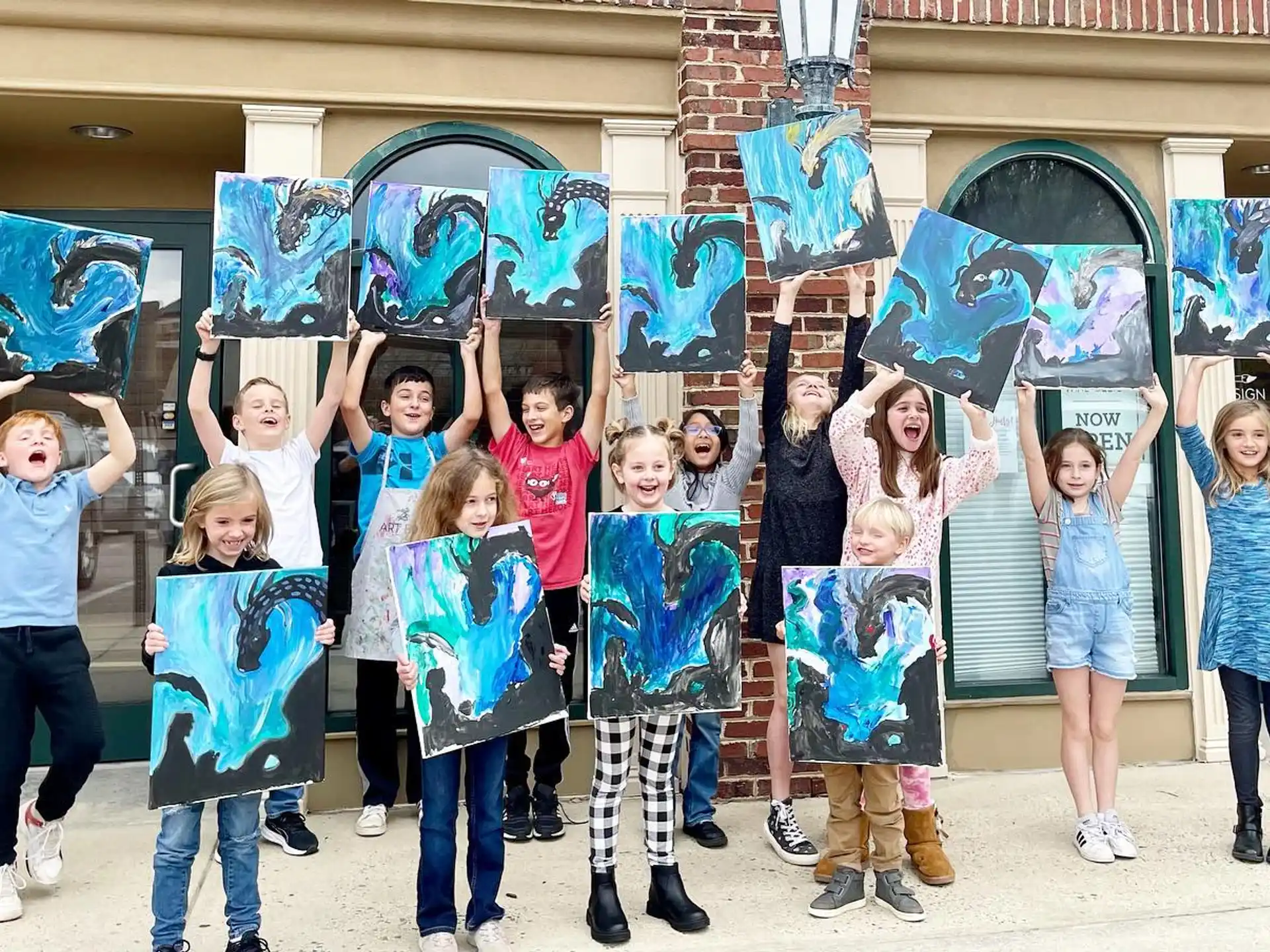 a group of children holding skateboards