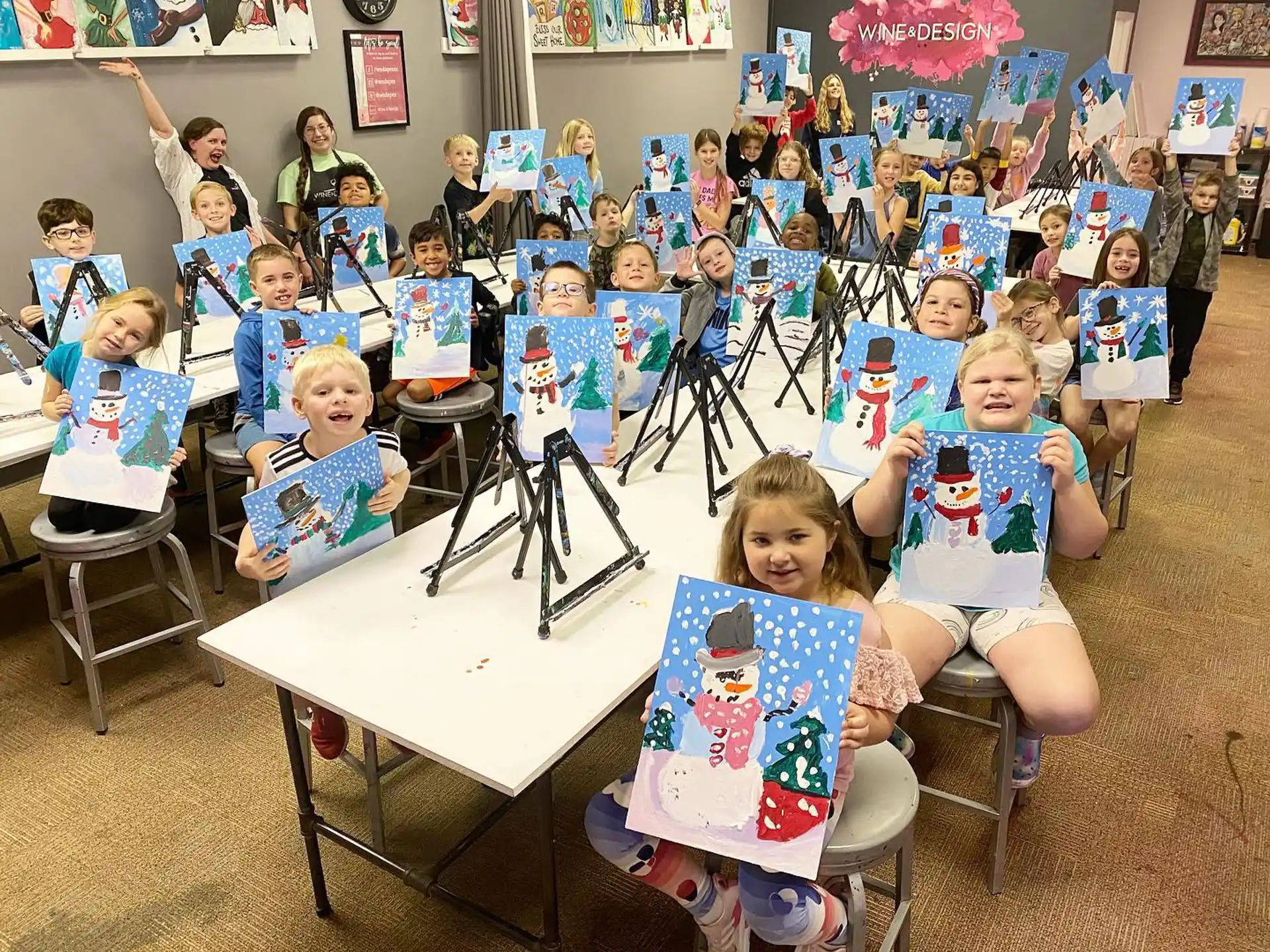 a group of children sitting at a table with a microphone