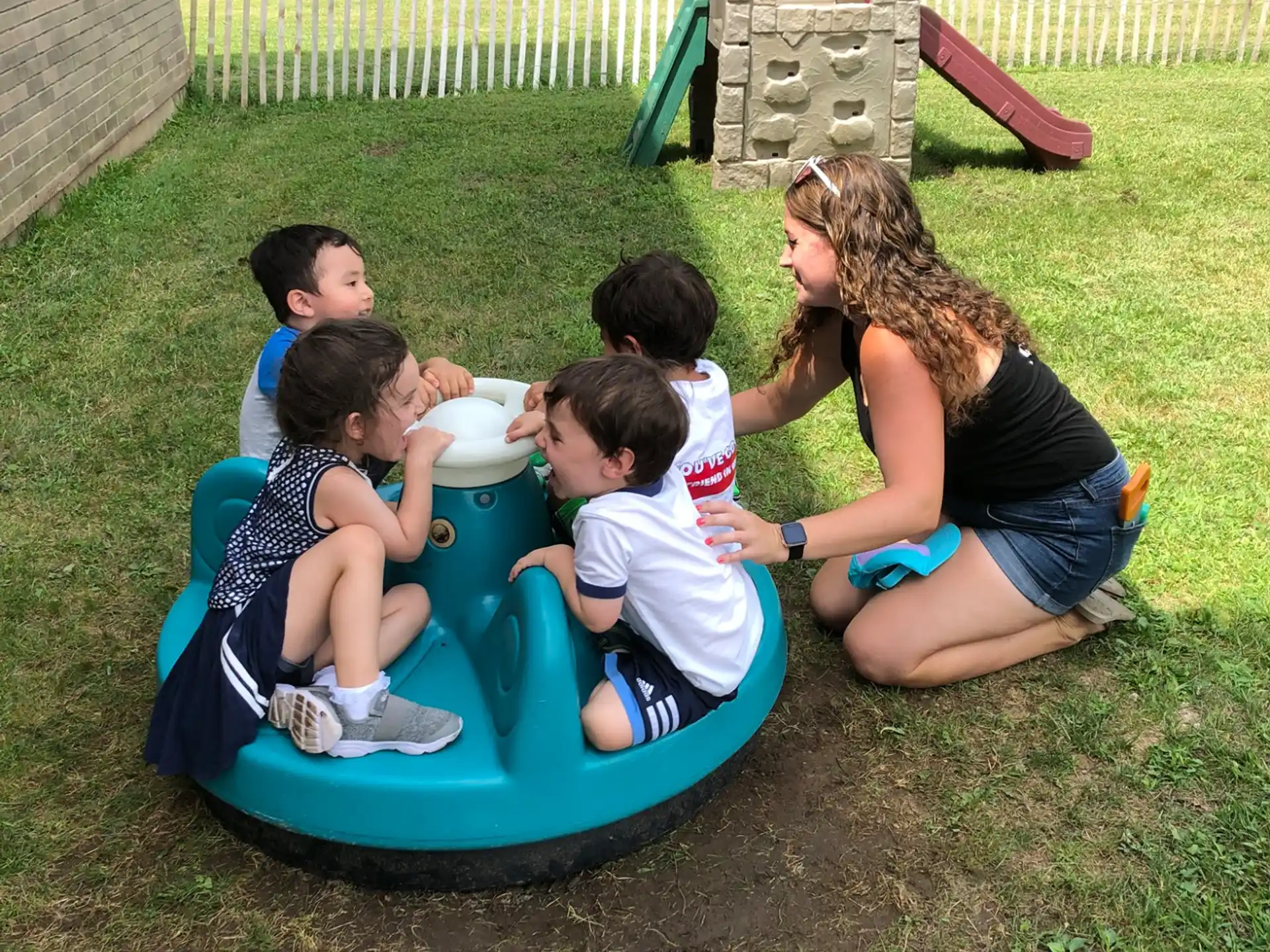 a group of people sitting on a blue and yellow trampoline