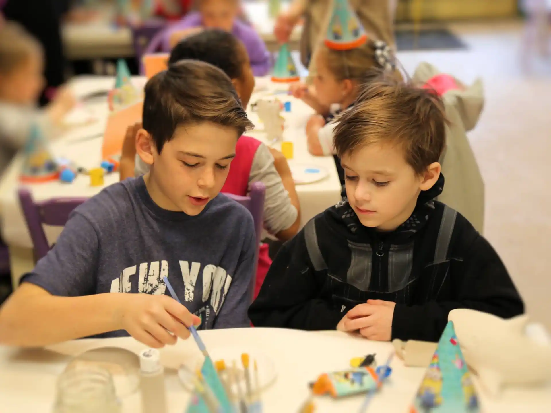 a group of children sitting at a table