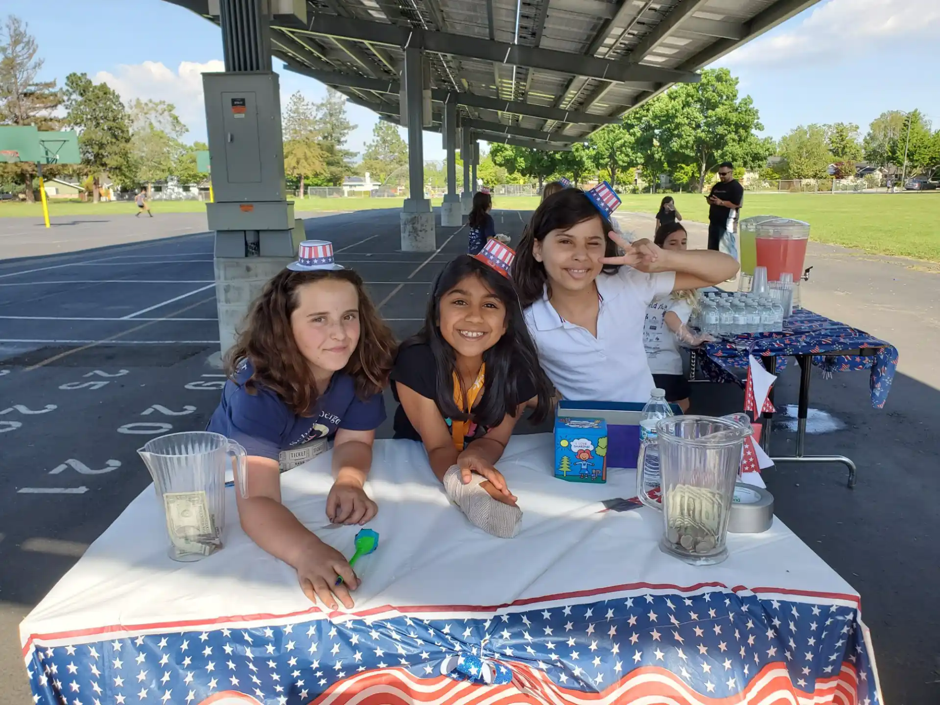 a group of women sitting at a table with food and drinks