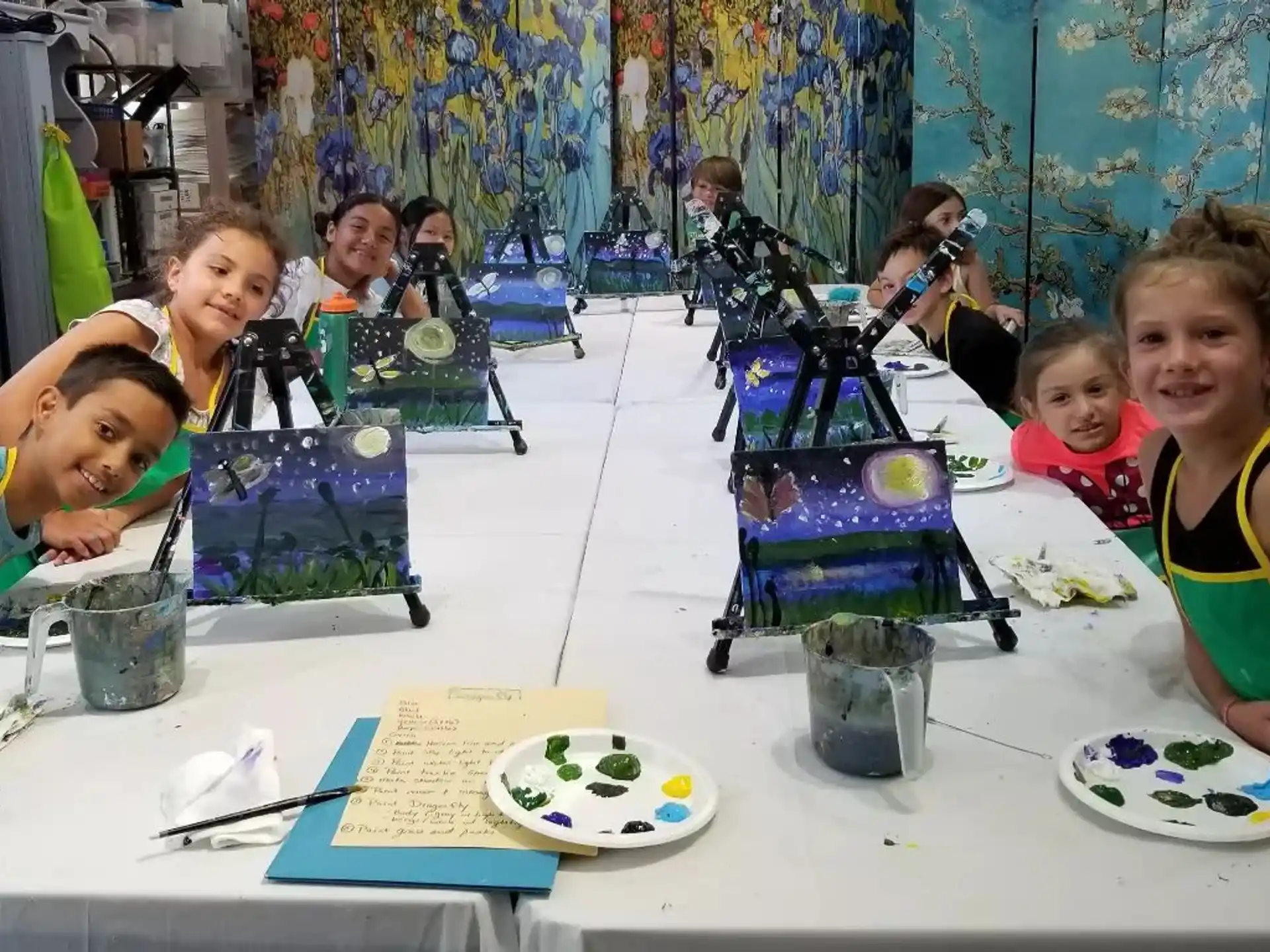 a group of children sitting at a table
