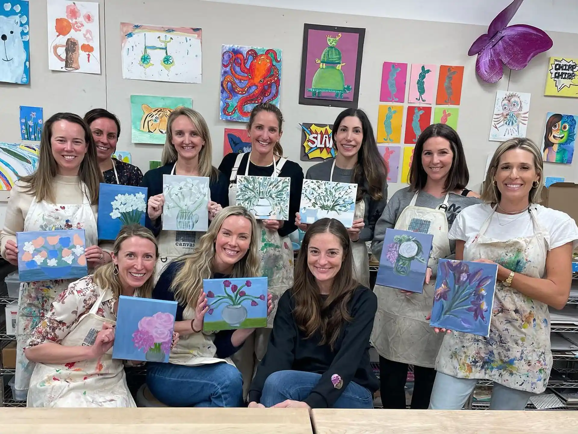 a group of girls holding up books