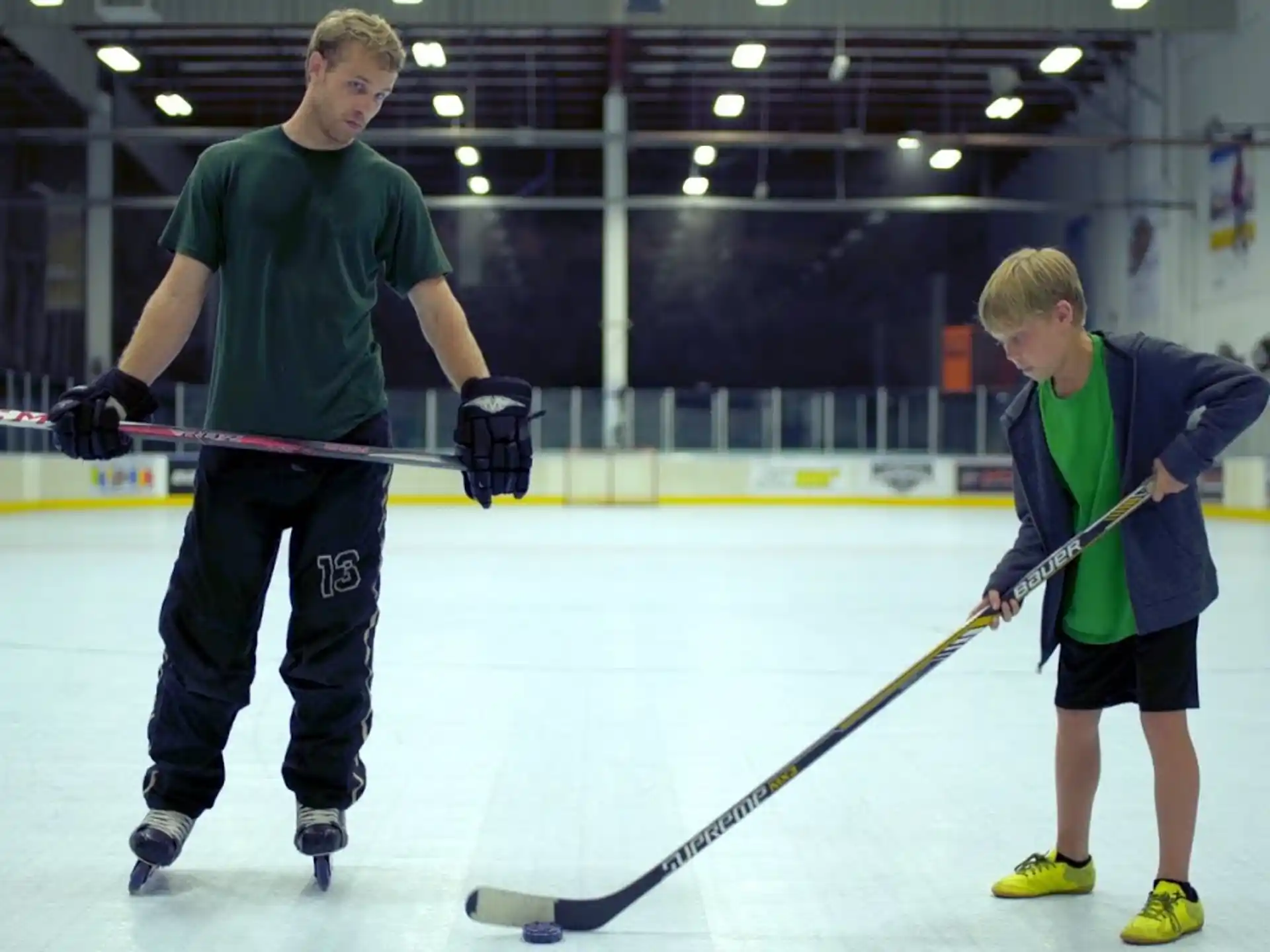 a couple of men playing hockey