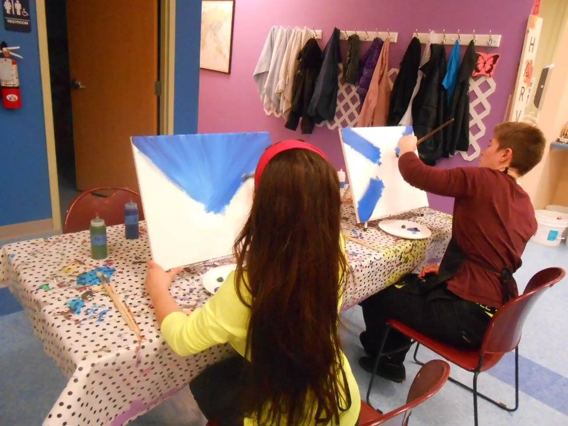 a man and woman painting
