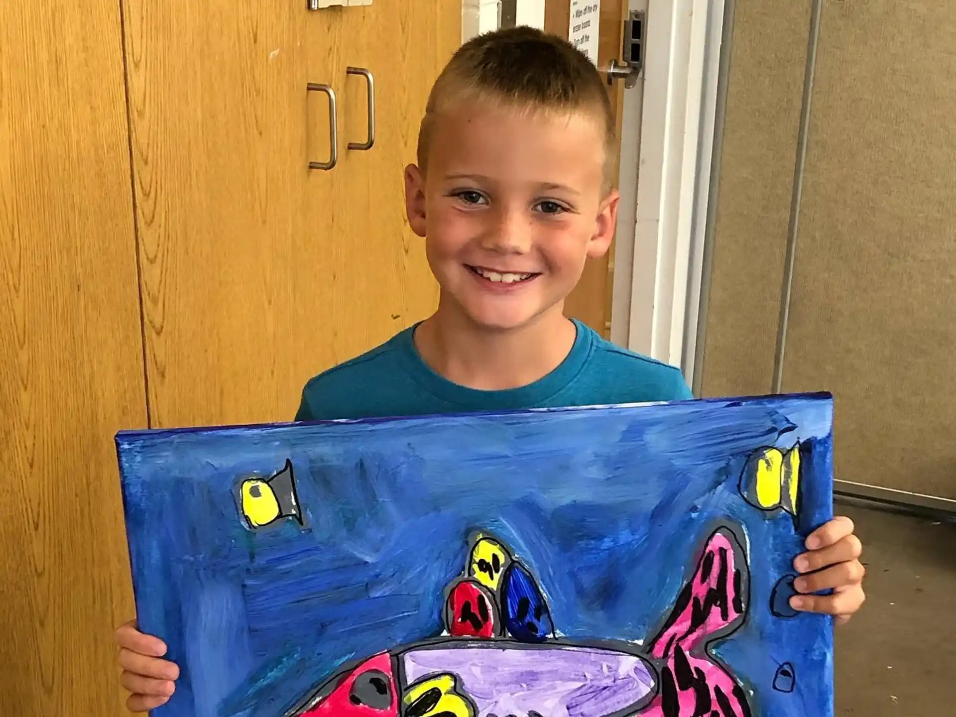 a boy holding a blue box