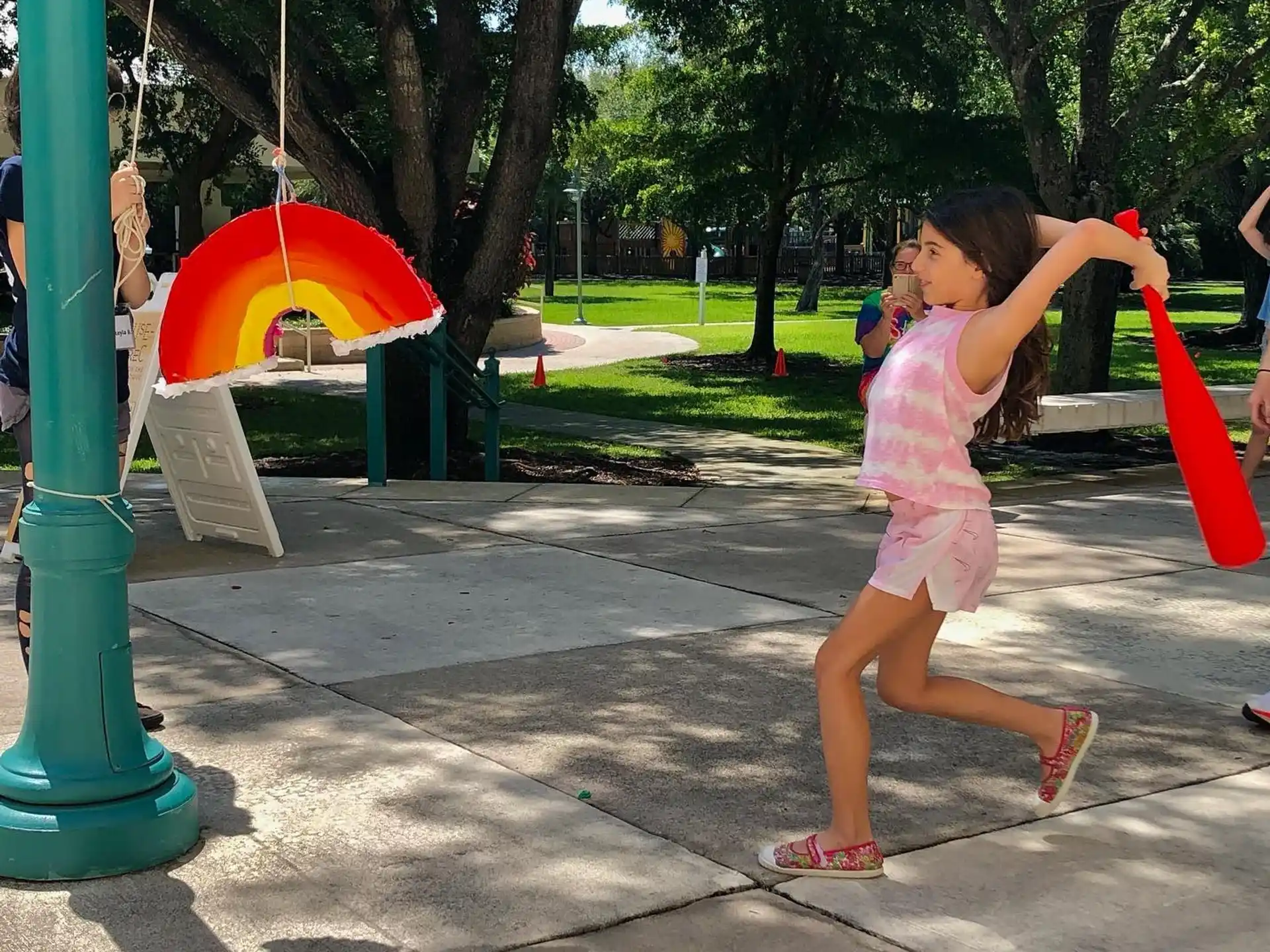 a girl swings a red umbrella