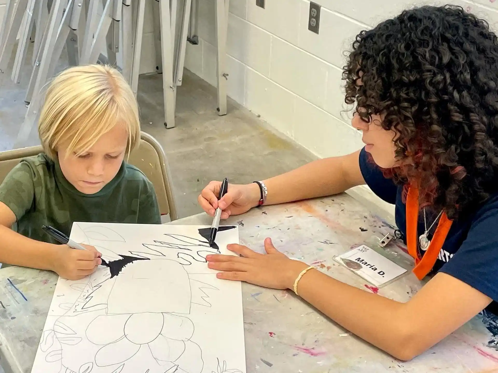 a person and a child drawing