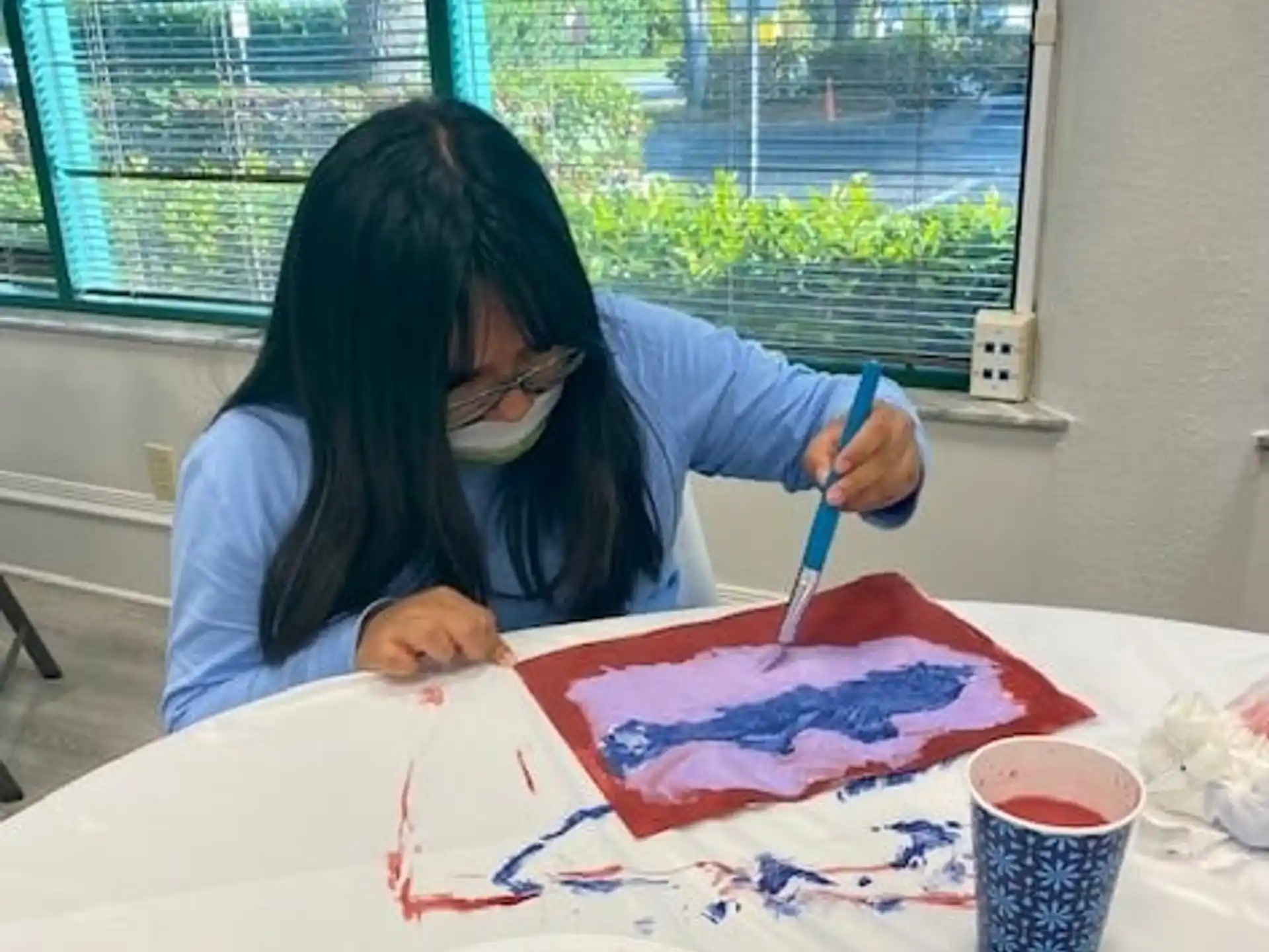 a woman painting on a table