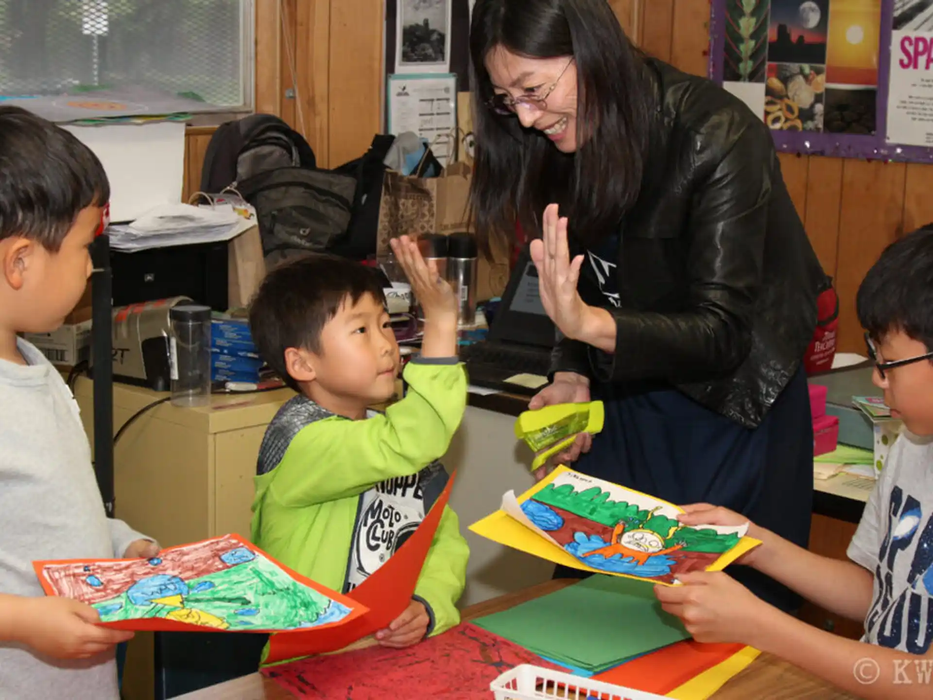 a person and several children in a classroom