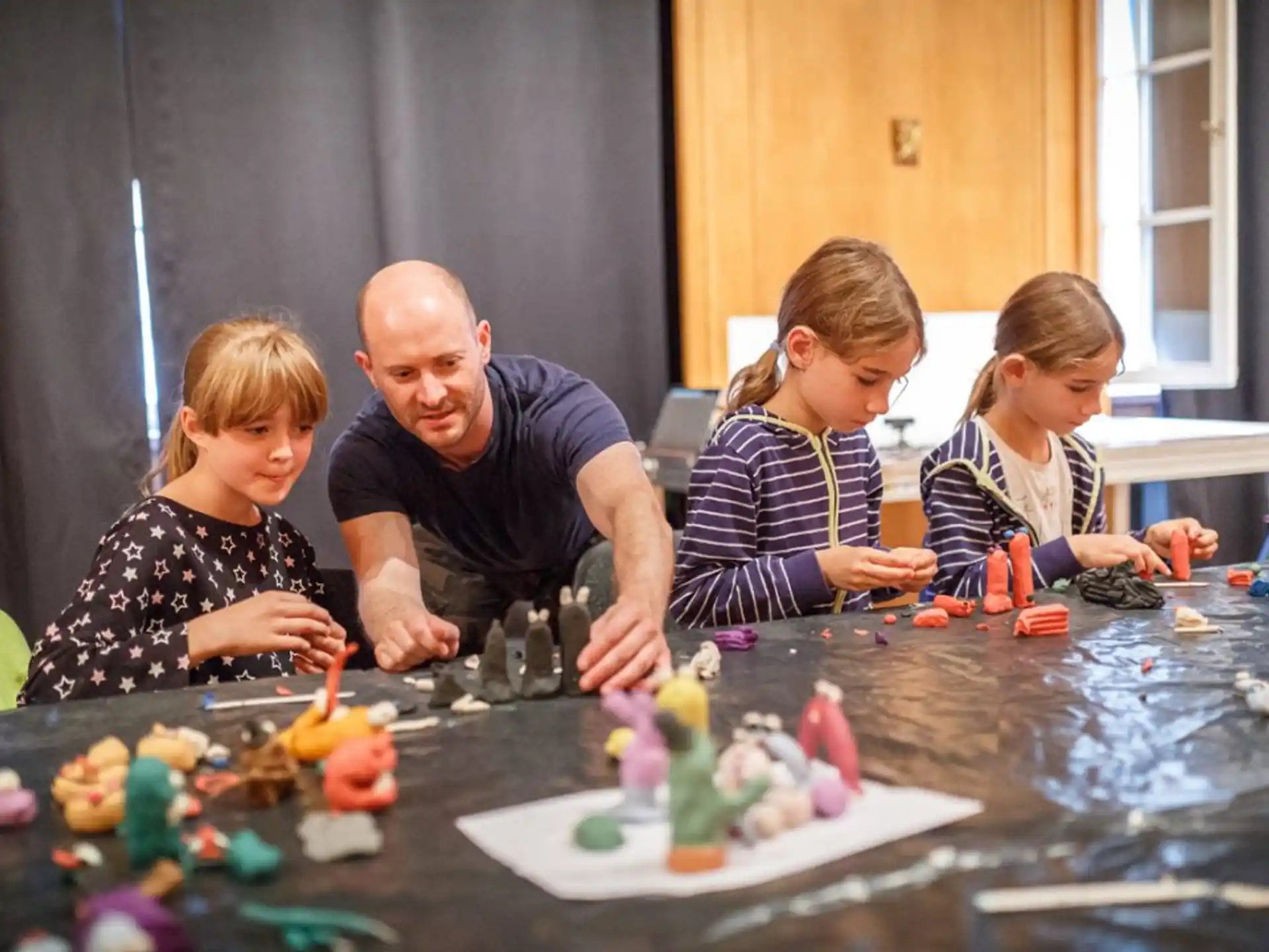 a person and a group of children playing with toys