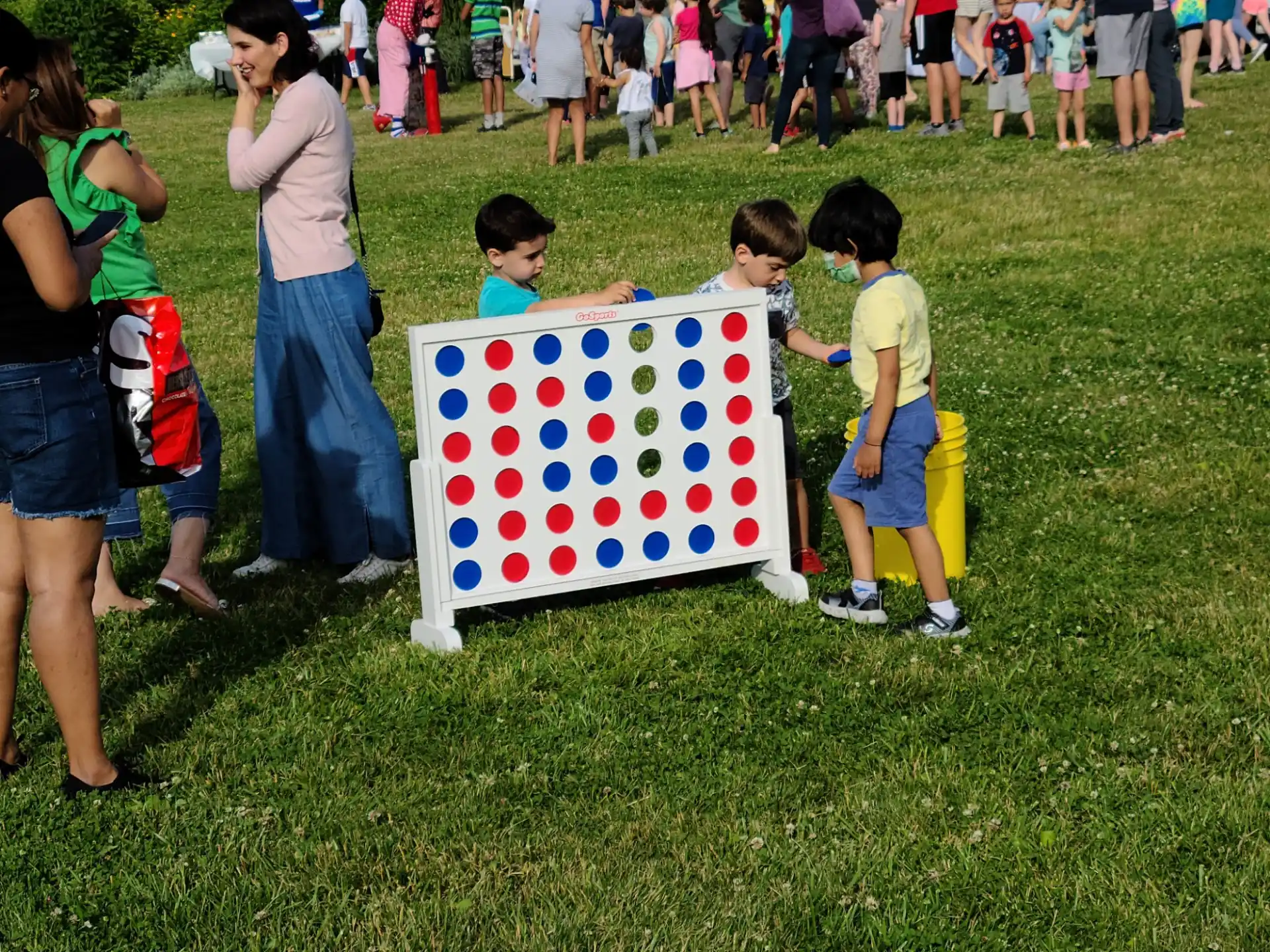 a group of children standing around a flag