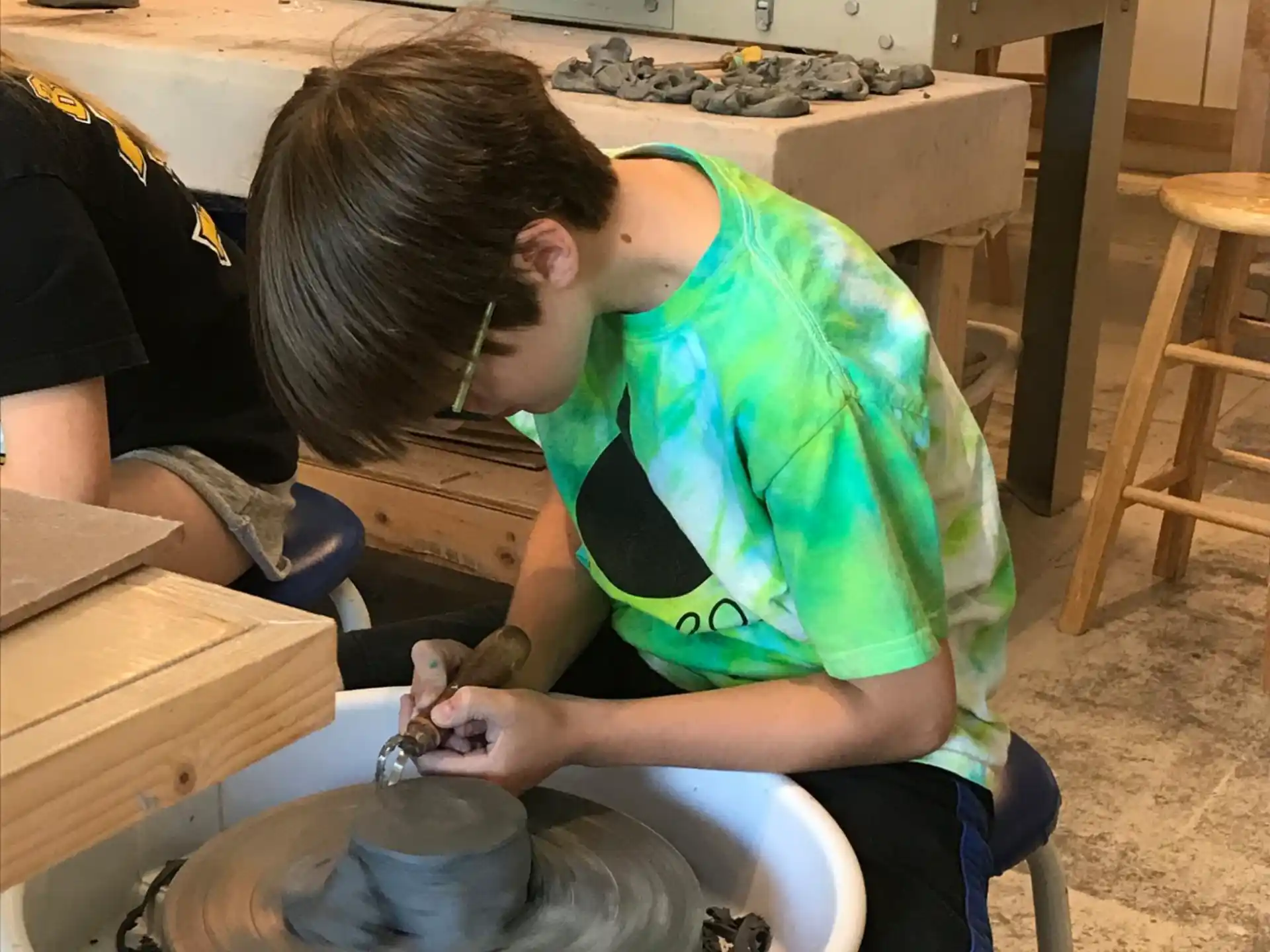 a person pouring liquid into a pot