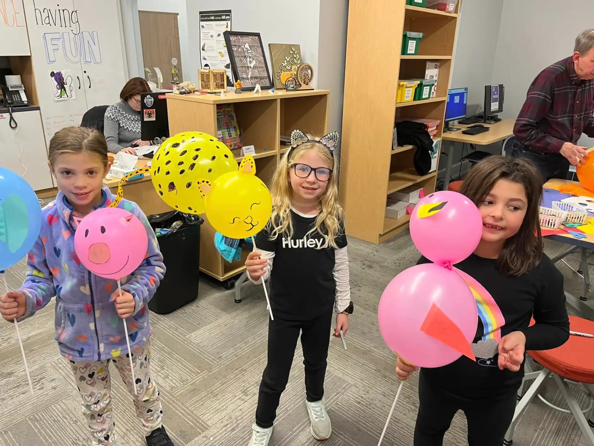 a group of children holding balloons