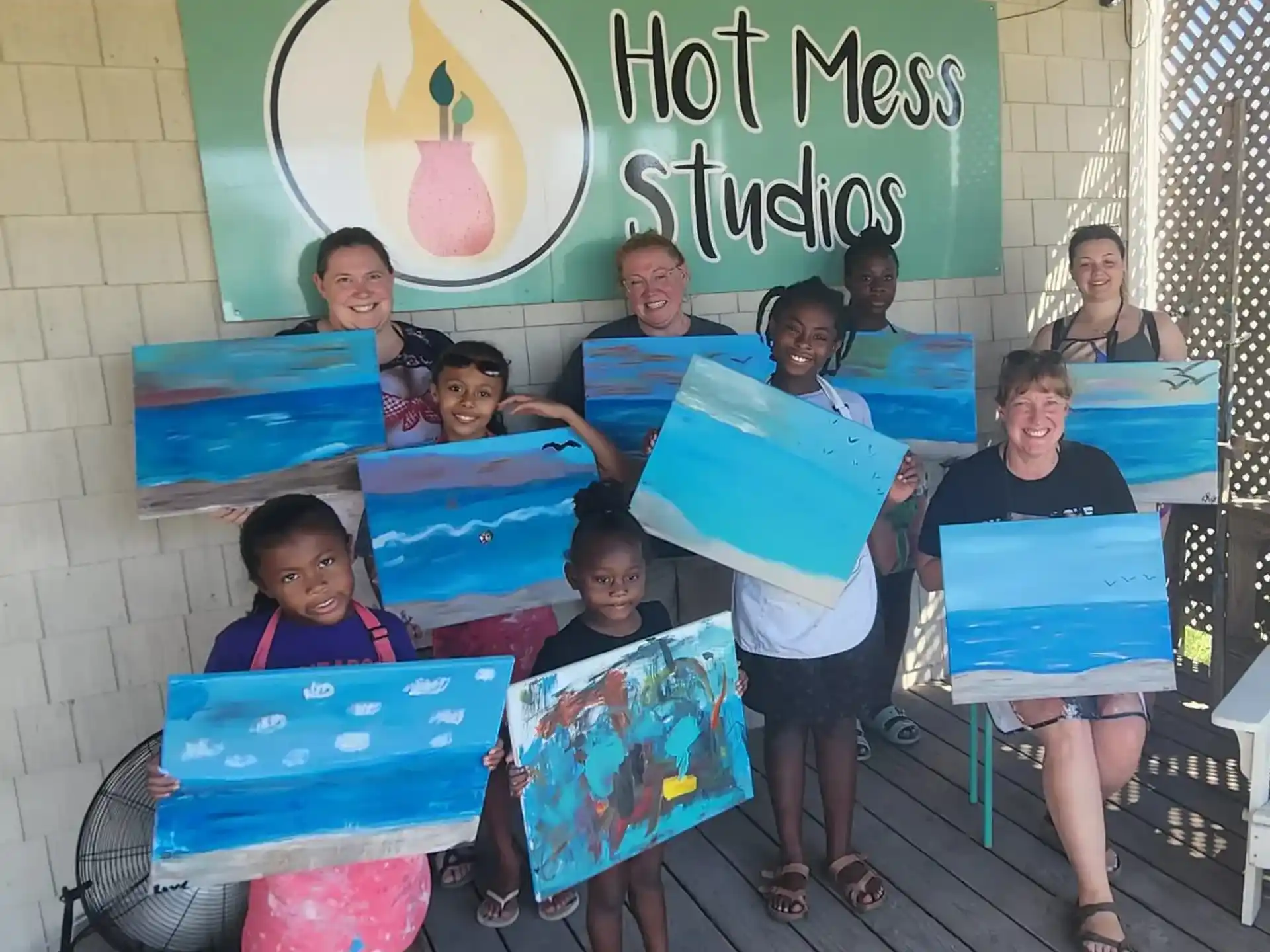 a group of children holding blue and white folders