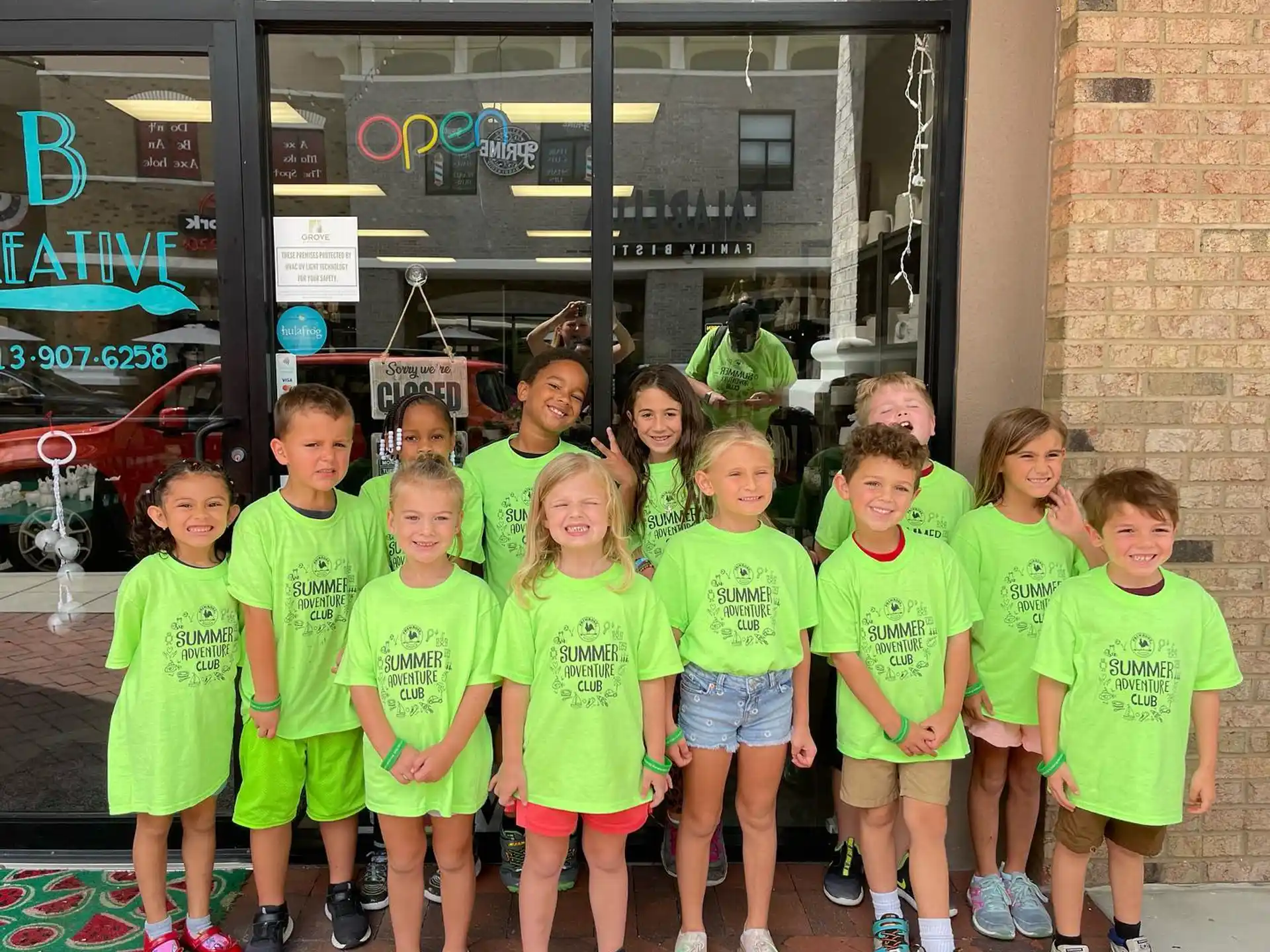 a group of children in green shirts