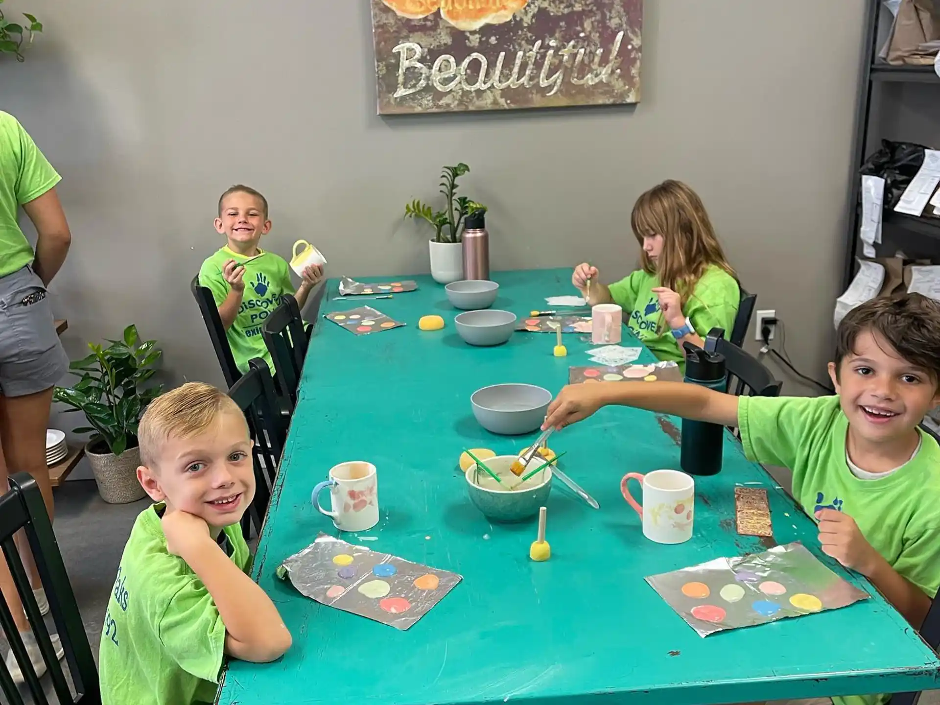 a group of children sitting at a table eating food