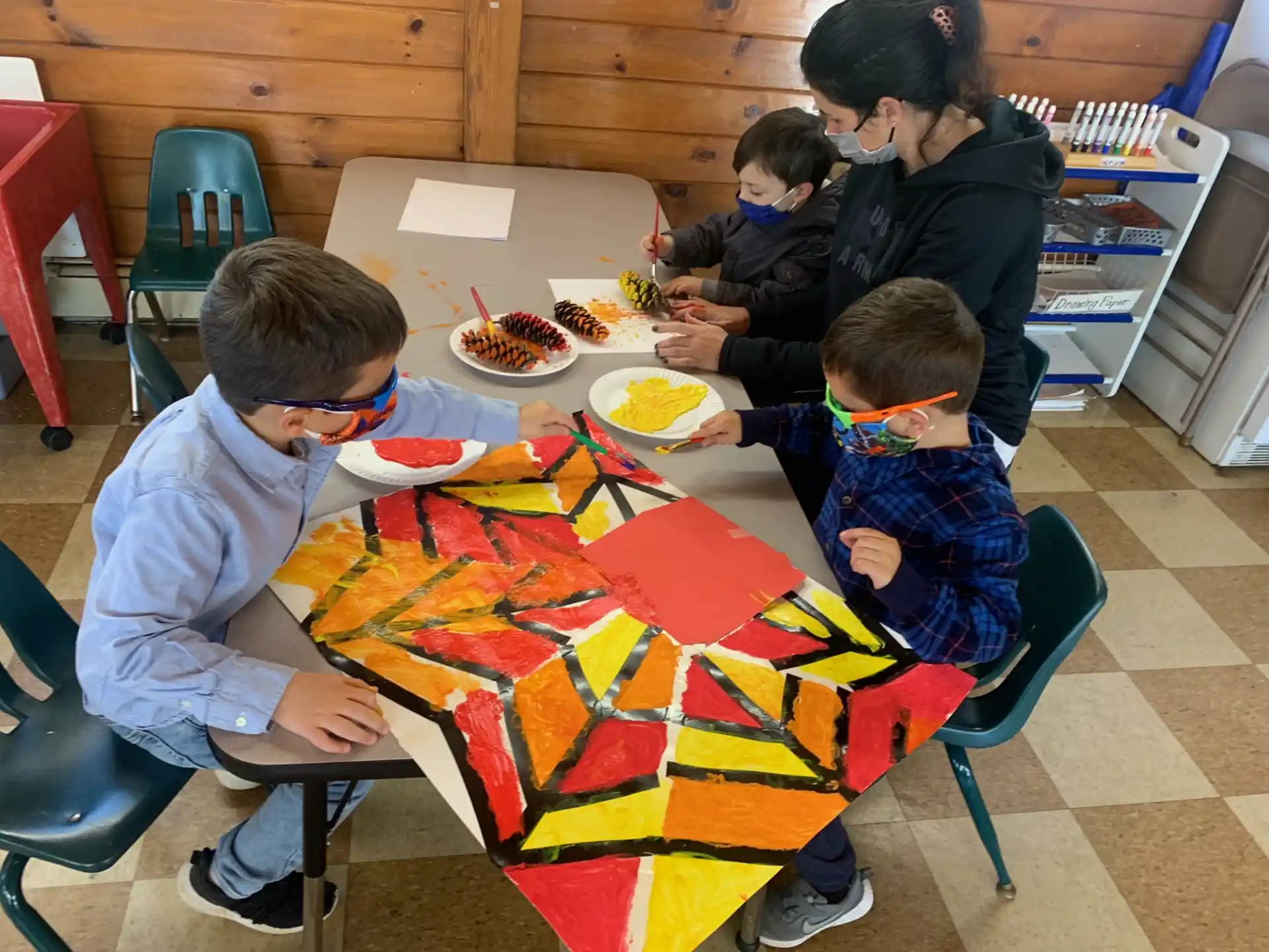 a group of people sitting at a table eating pizza