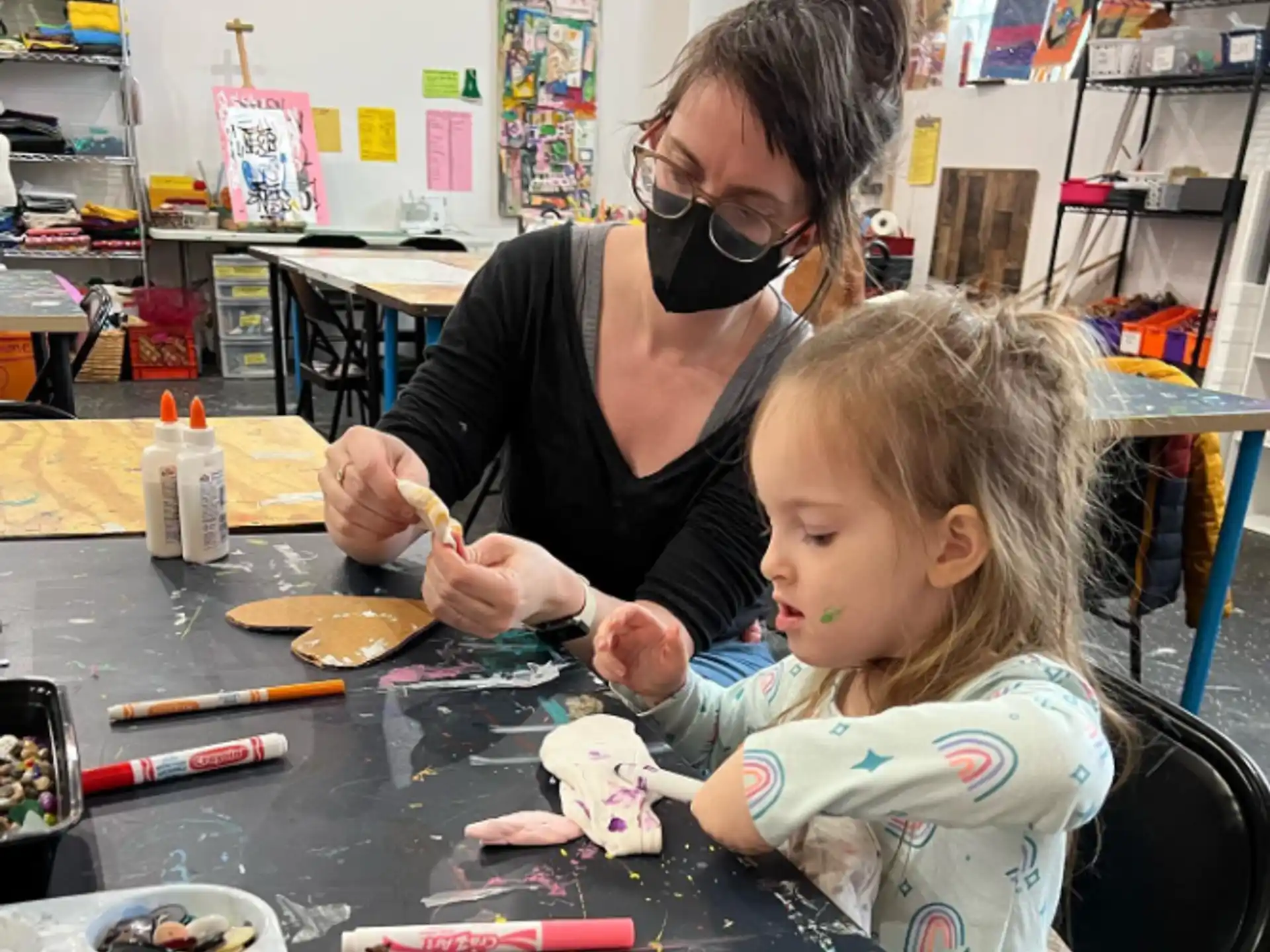 a person and a child painting