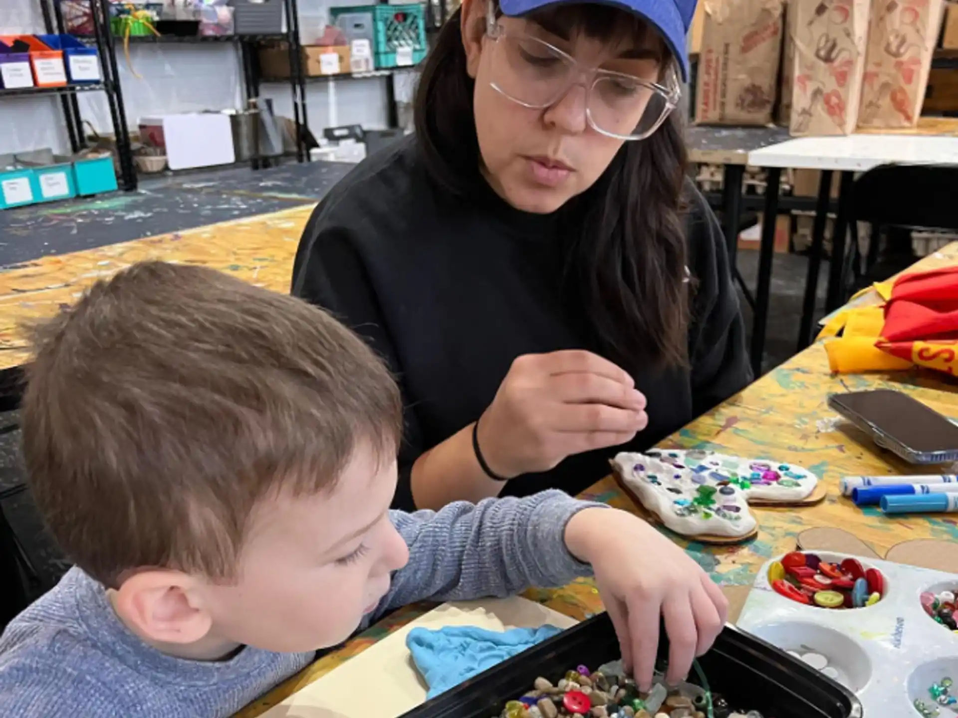 a woman and a boy playing with toys