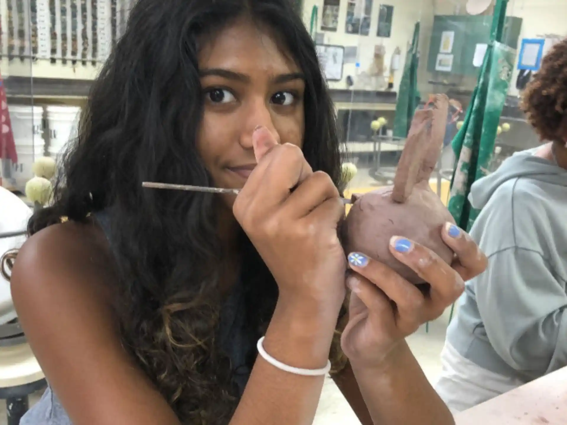 a woman holding a cigarette and a straw in her mouth