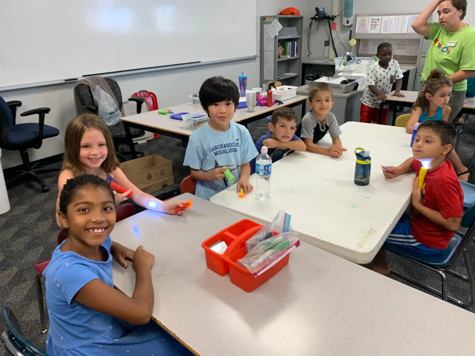 a group of children sitting around a table