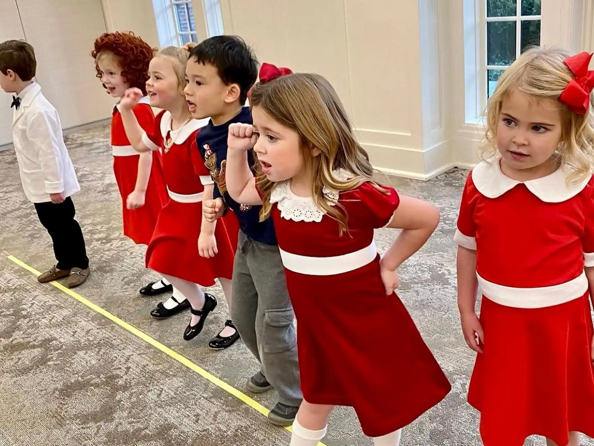 a group of children in red and white clothing
