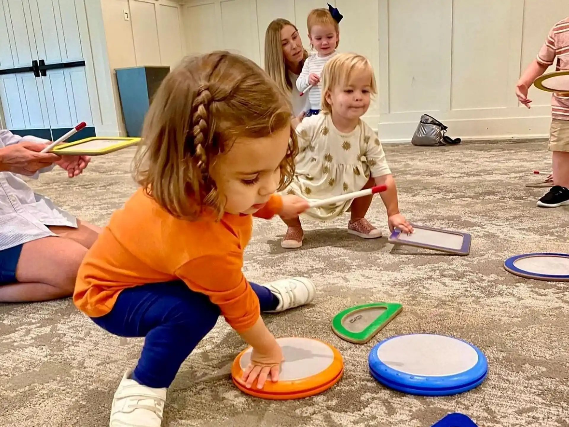 a group of children playing with plastic plates