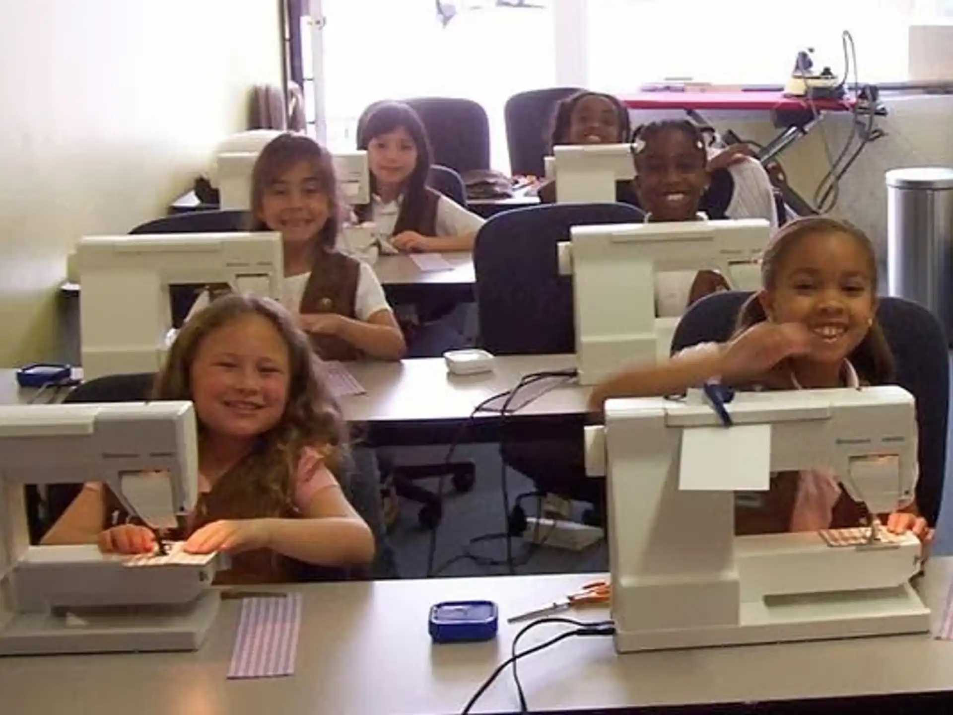 a group of people sitting at desks in a room