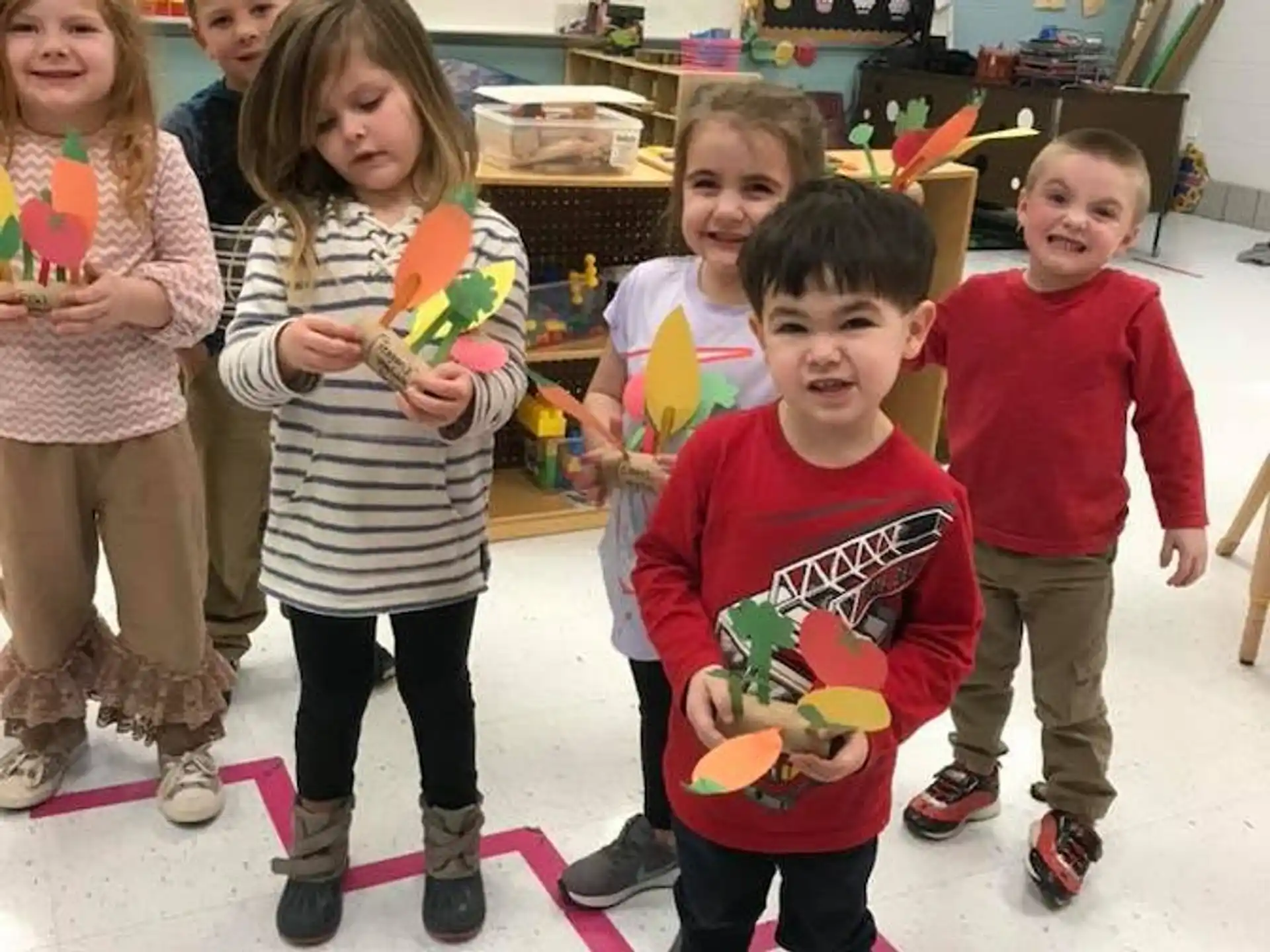 a group of children holding toys