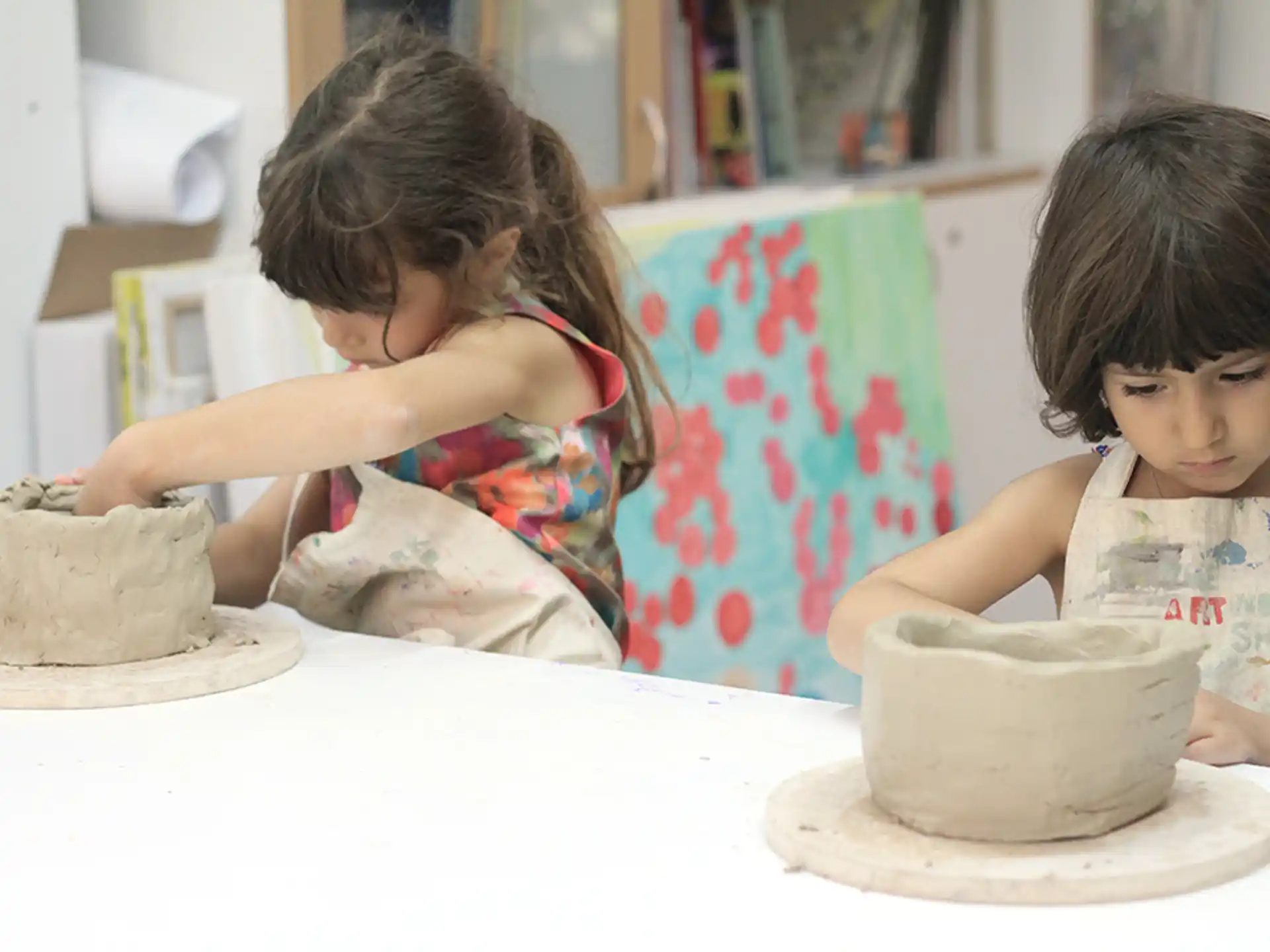 a couple of kids playing with a cake