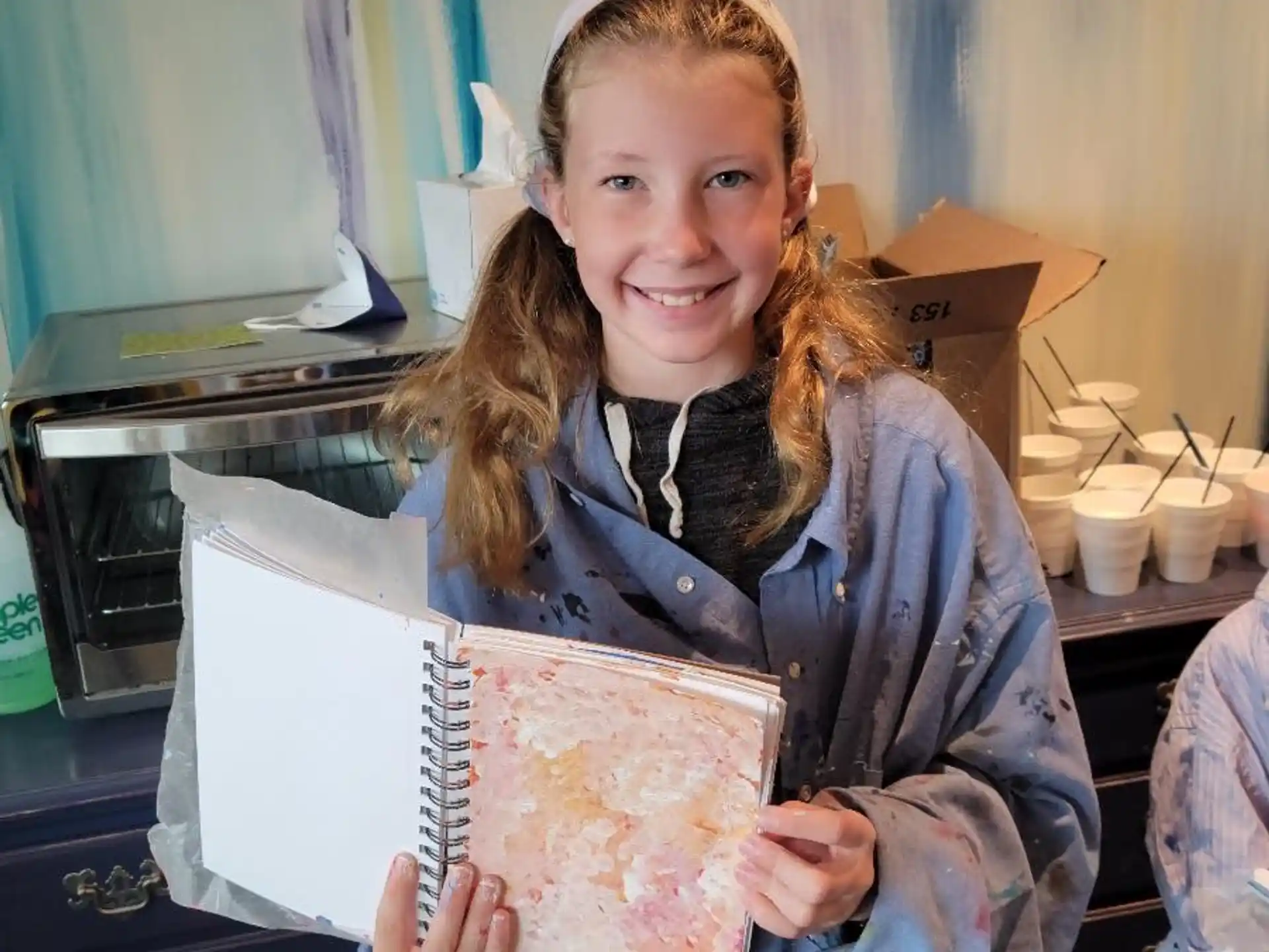 a girl holding a piece of paper