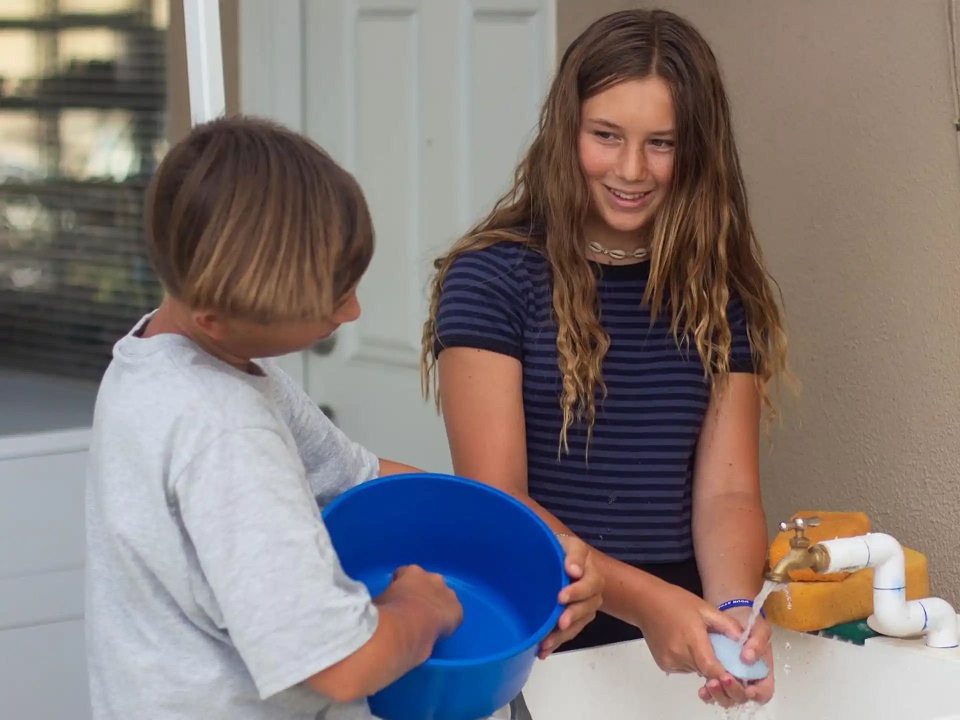 a person and a boy playing with a cupcake