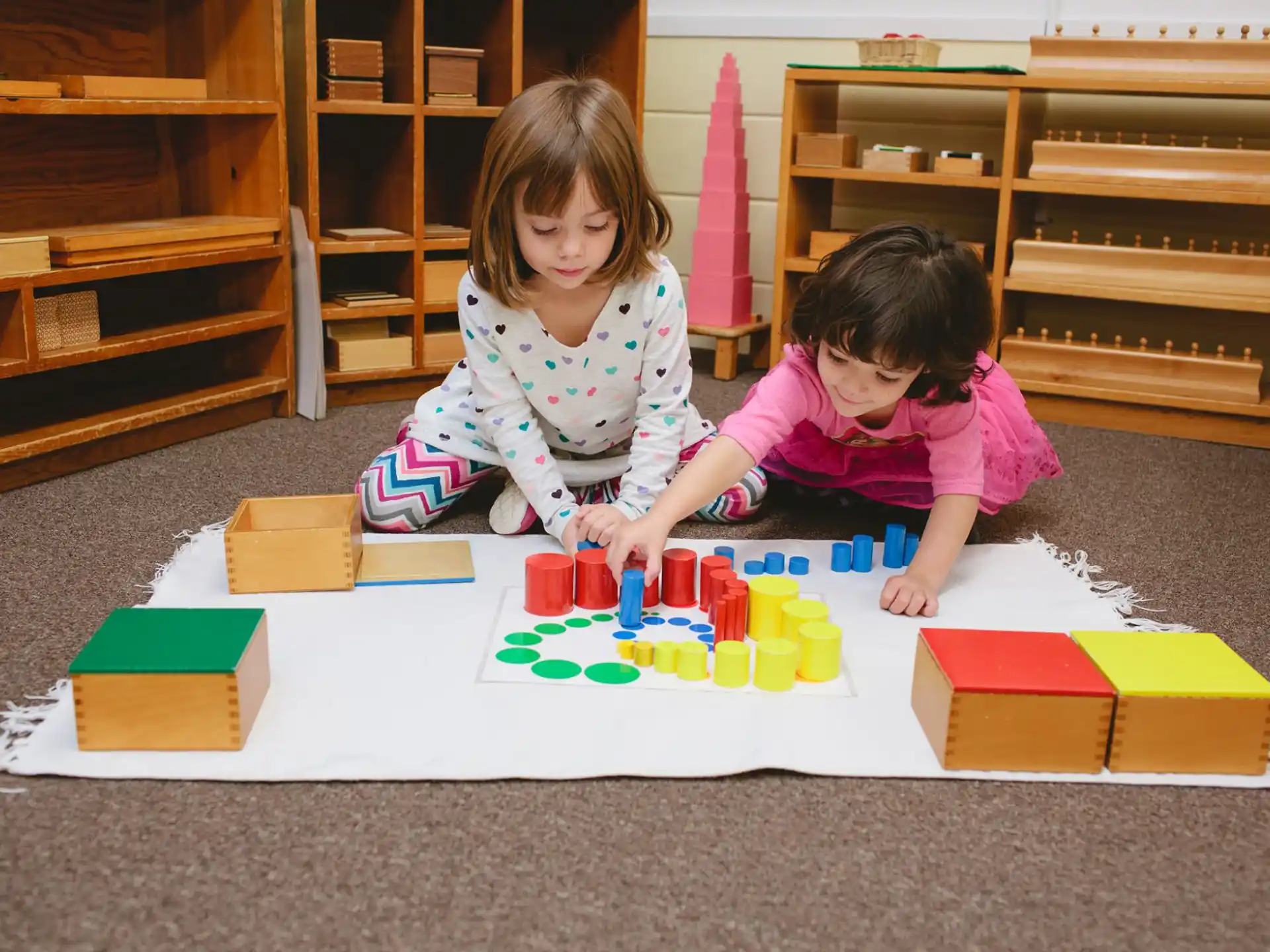a couple of kids playing with building blocks