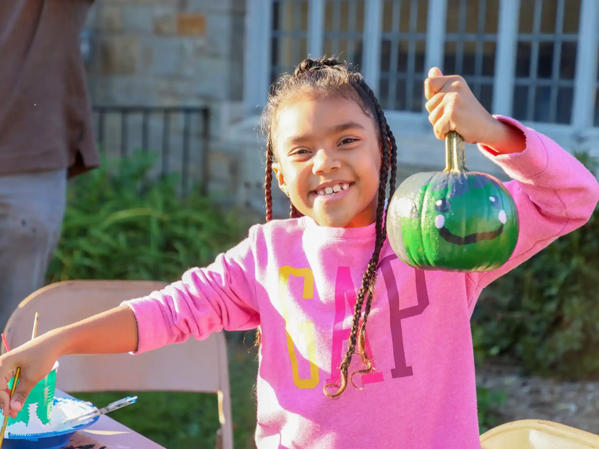a girl holding a green balloon