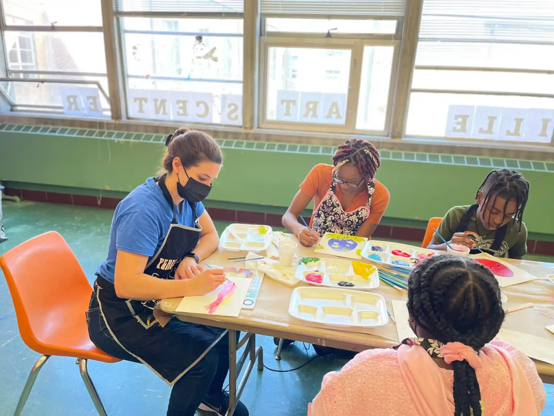 a group of people sitting around a table with food on it