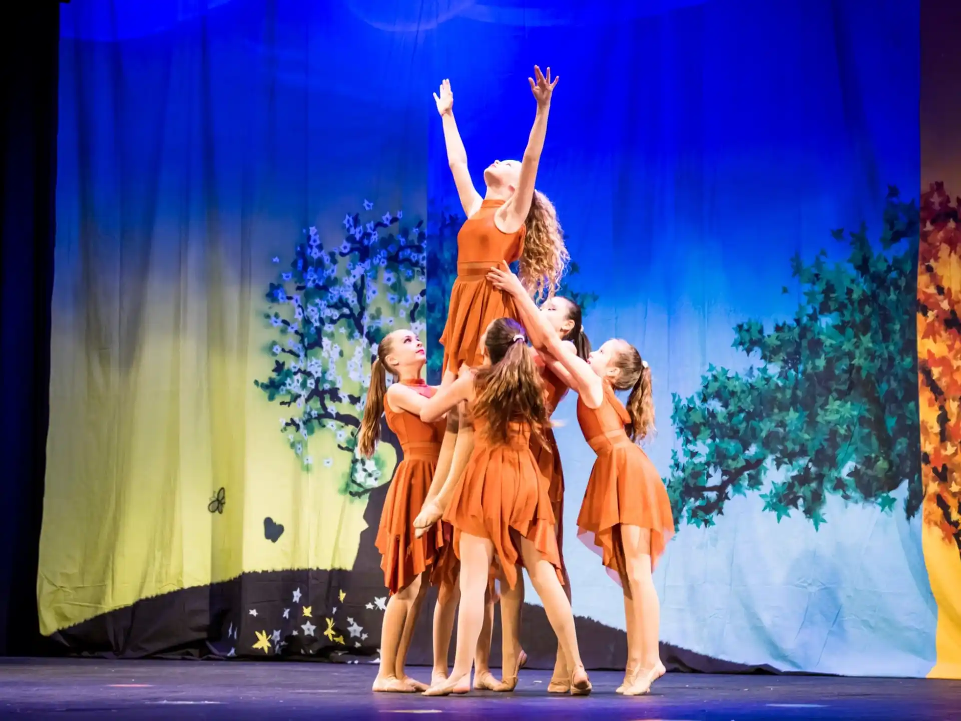 a group of girls dancing on a stage