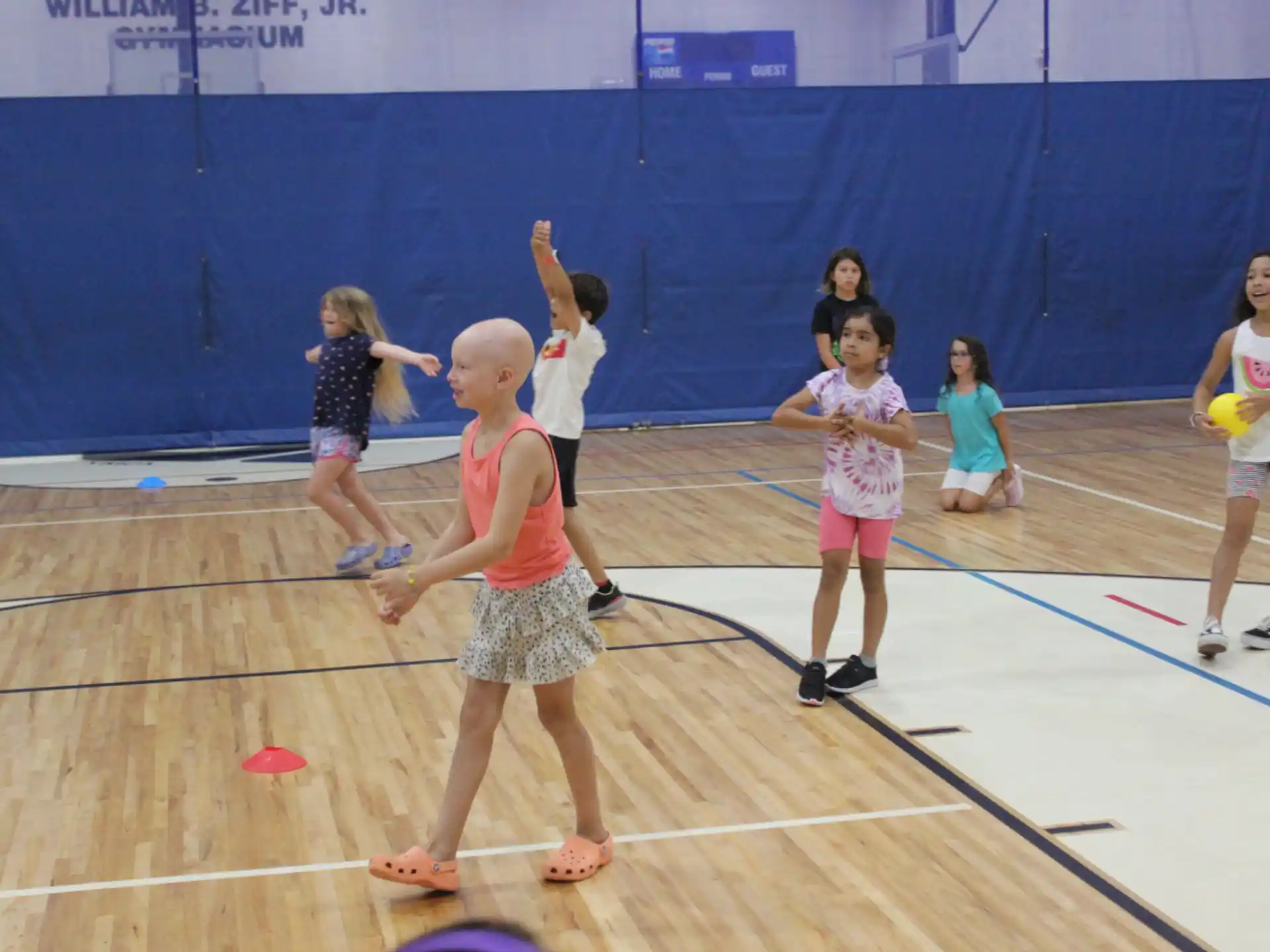 a group of children playing volleyball