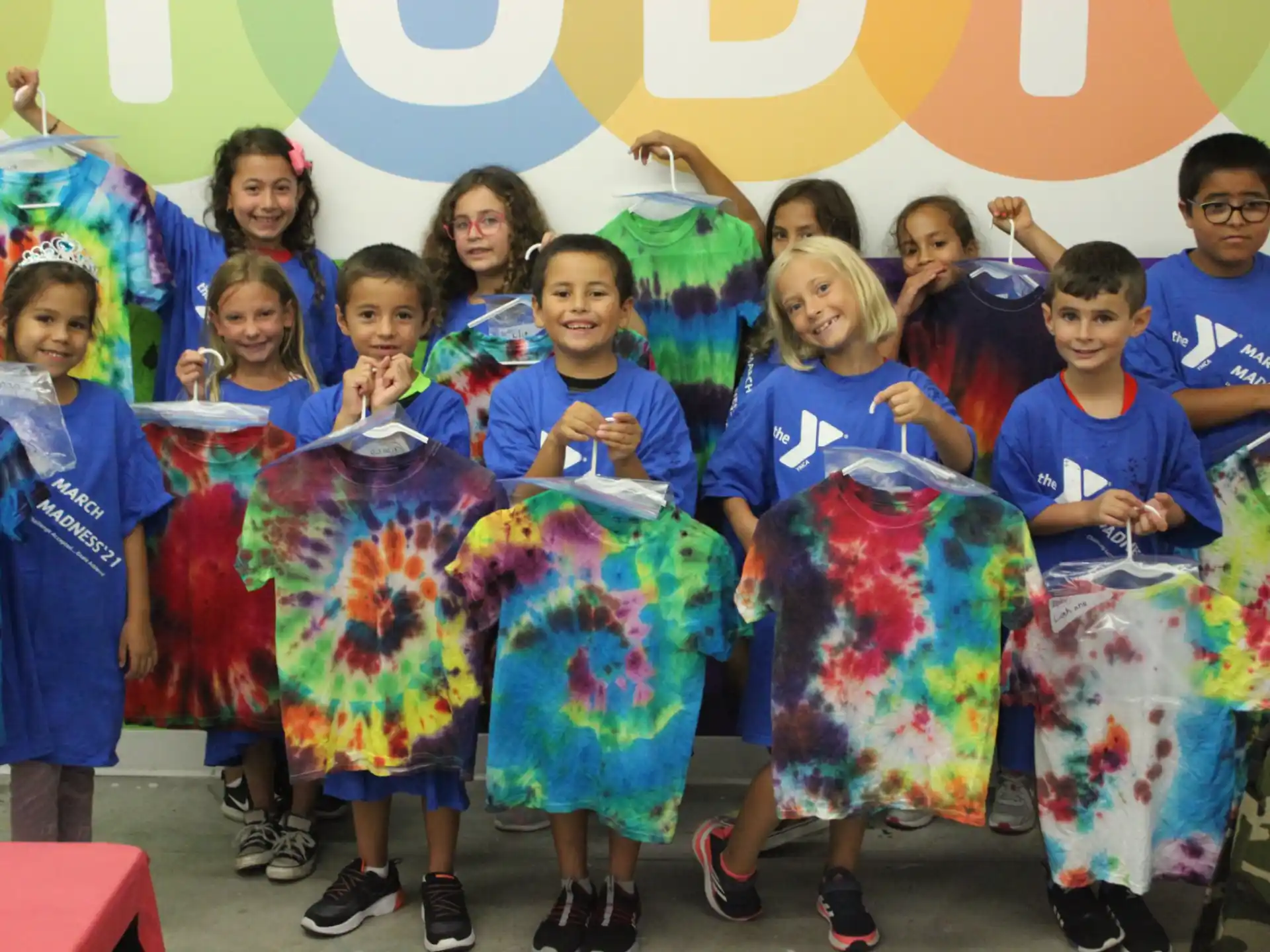 a group of people wearing colorful dresses