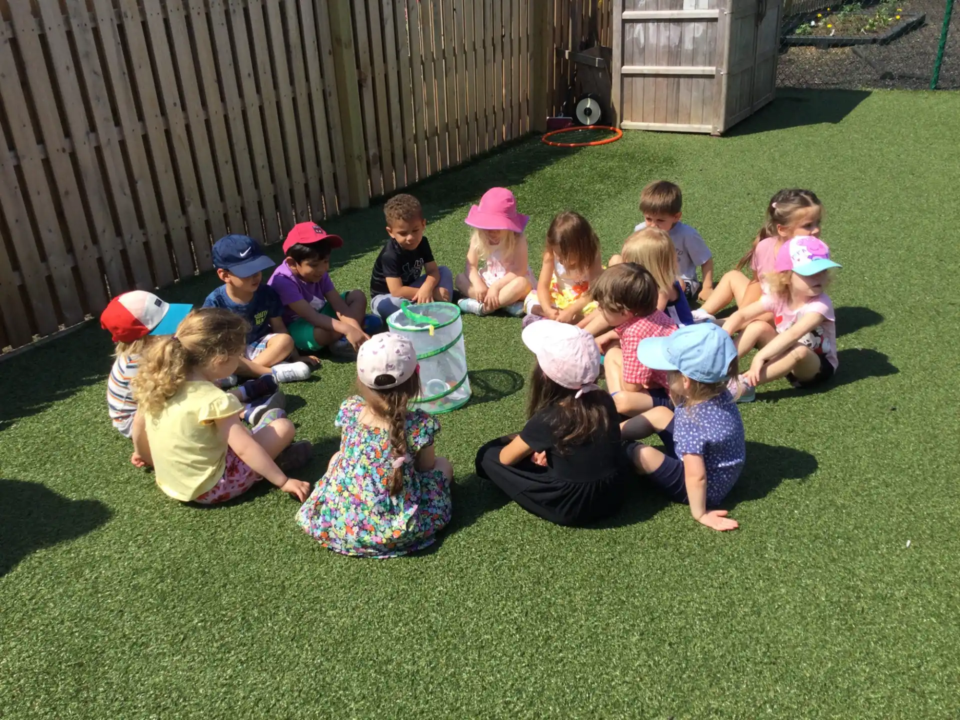 a group of children sitting on the grass